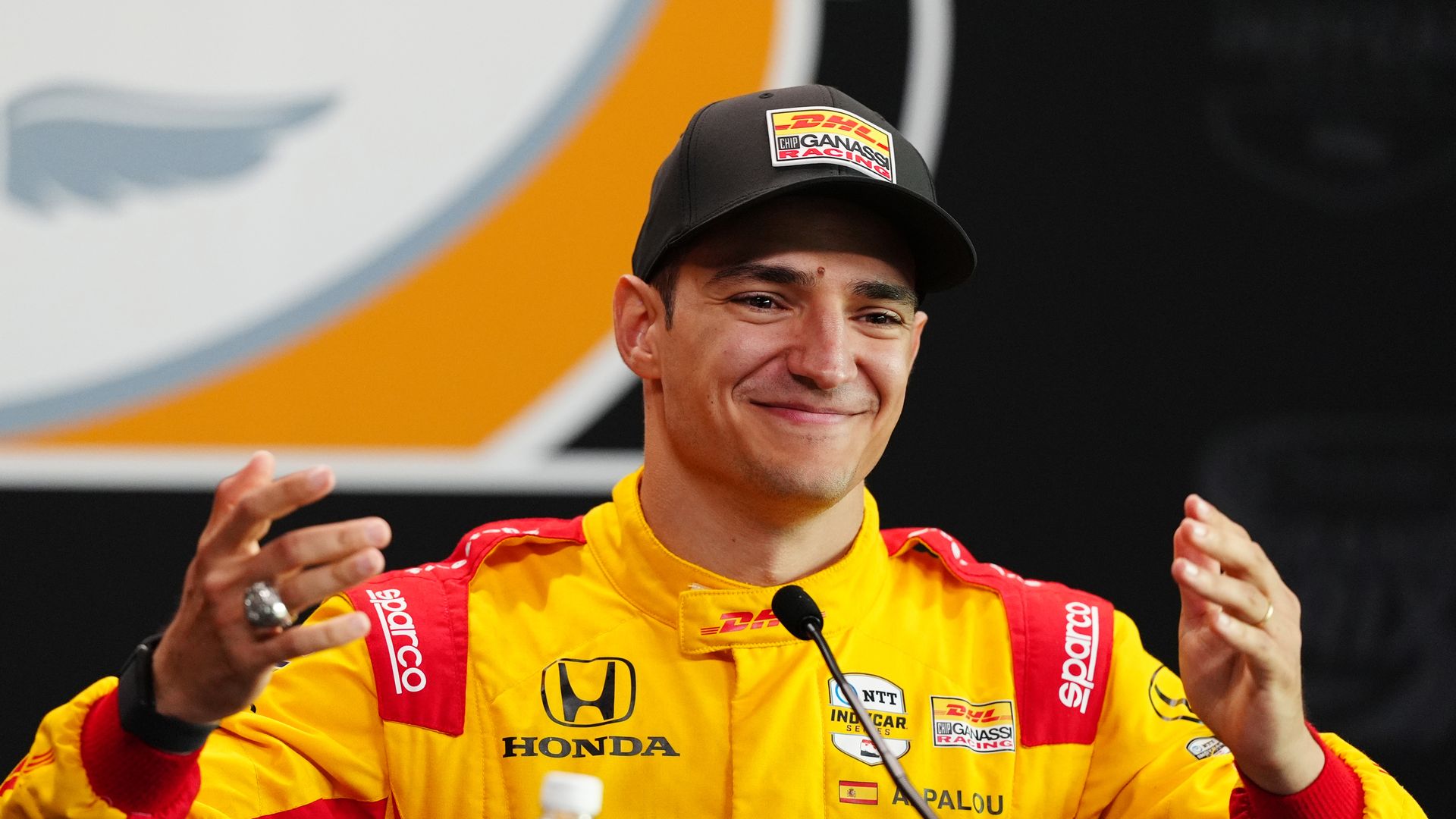 A racecar driver in a yellow suit