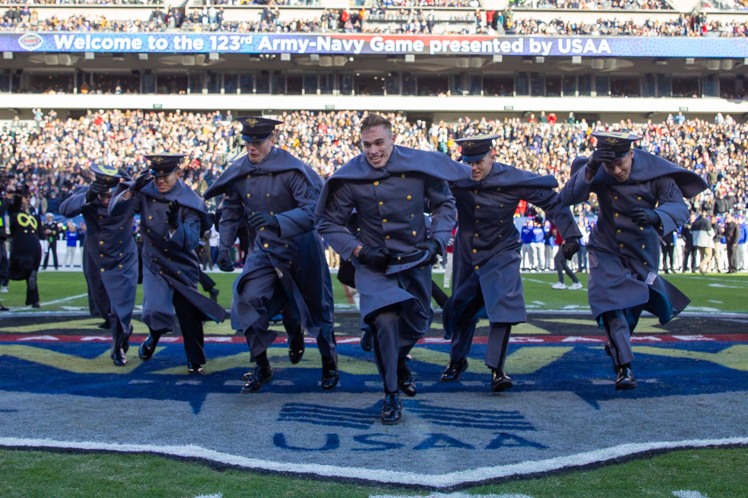 Army Black Knights run to join their classmates after the prisoner exchange at Lincoln Financial Field on December 10, 2022 in Philadelphia.