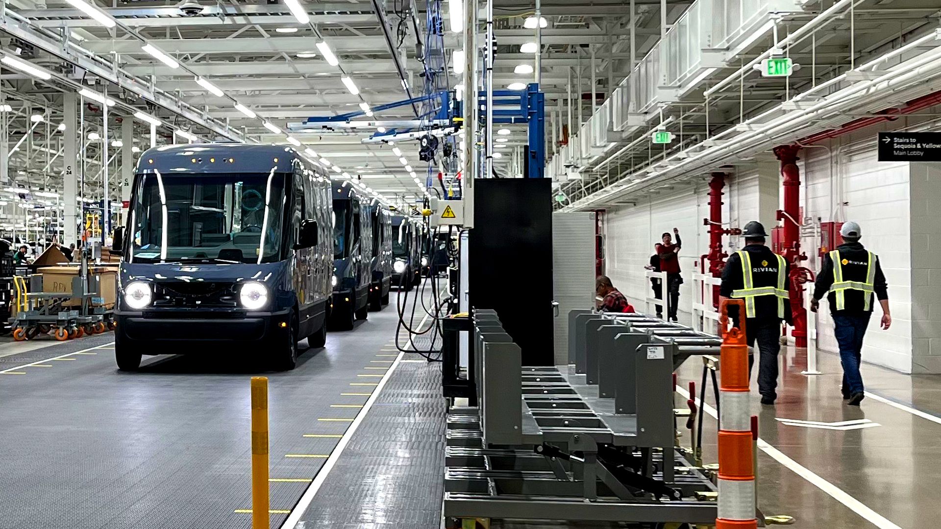 Image of Amazon electric delivery vans being built at a Rivian factory in Illinois. 