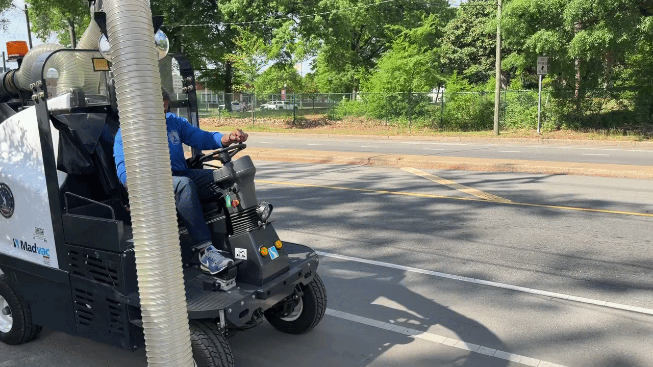 a gif of mayor avula drving the bike lane sweeper