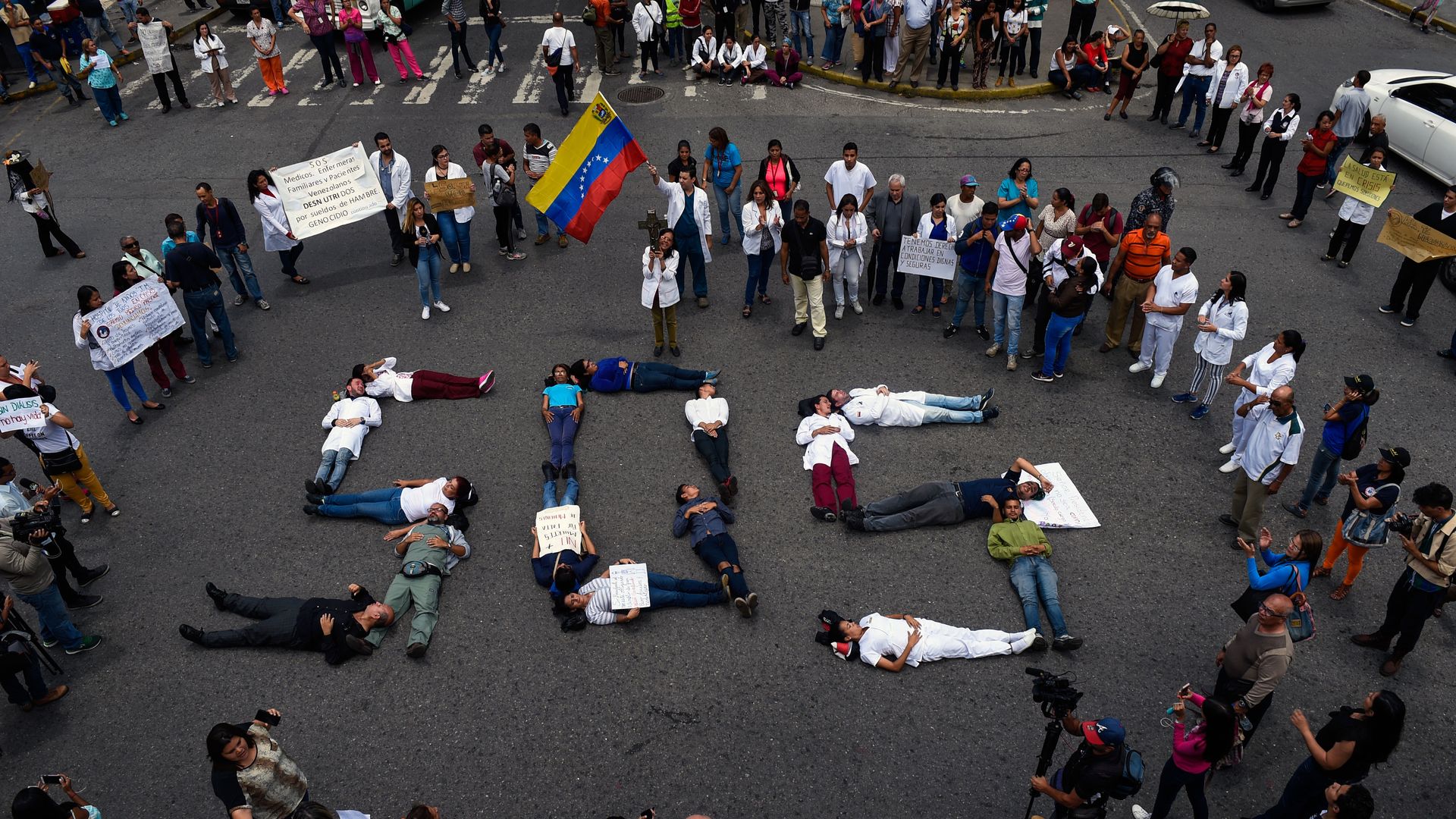 Venezuela protestors form SOS with their bodies