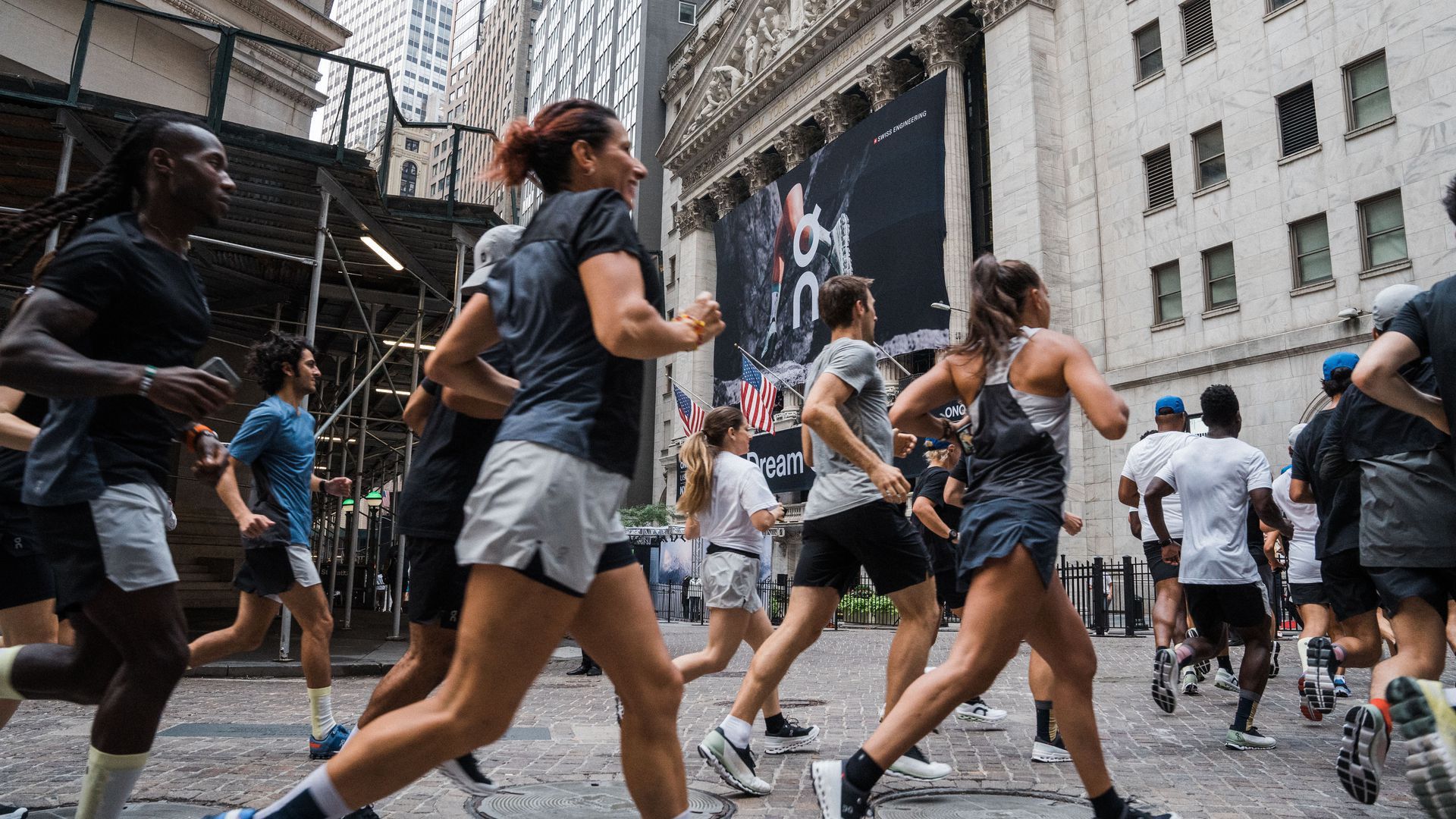 Photo of a group of people running in the streets in shorts and T-shirts