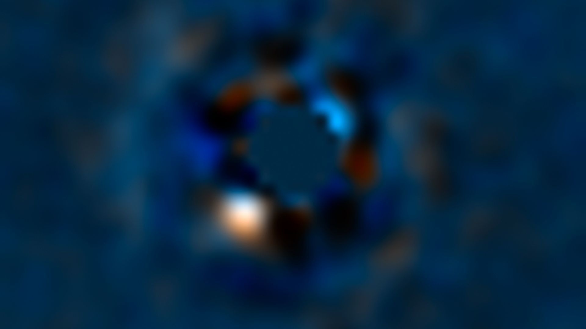 Photo of a blurry image that shows a bright spot and colorful swirls around it