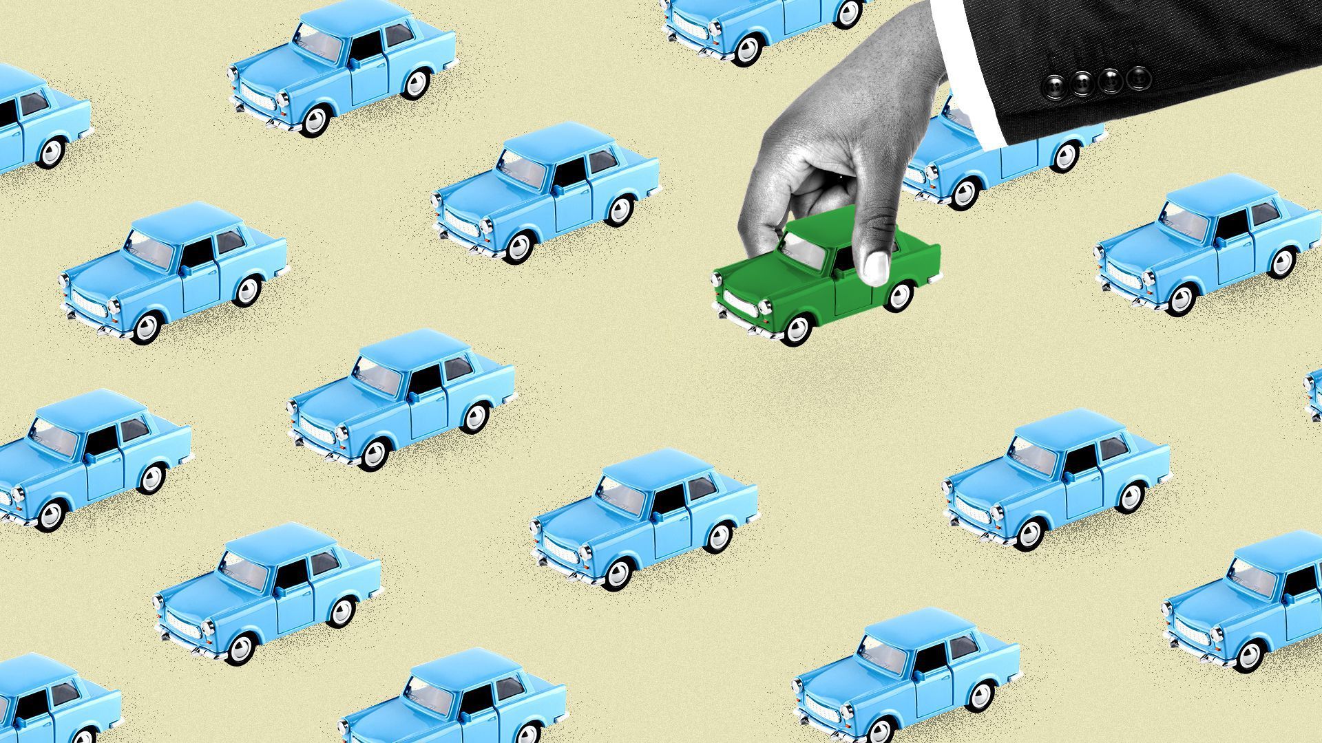 and hand picking up a small green car