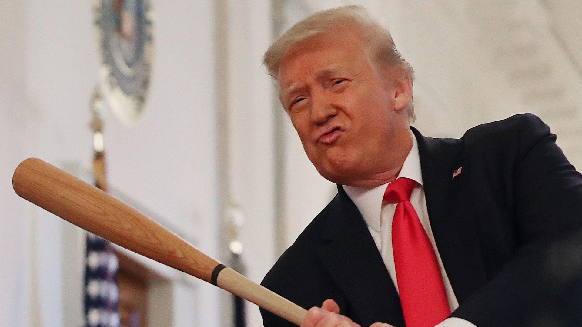 President Donald Trump holds a baseball bat while looking at exhibits during a Spirit of America Showcase in the Entrance Hall of the White House July 02, 2020