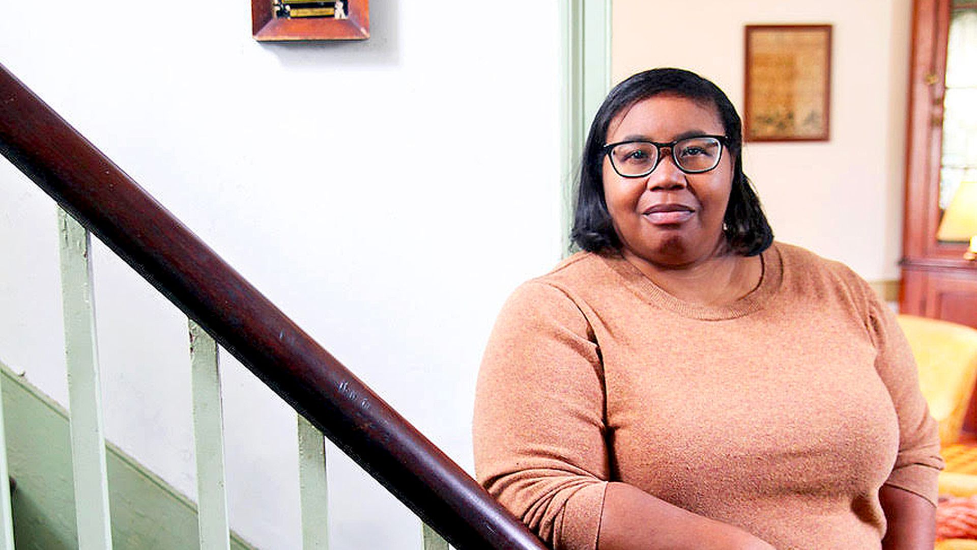 Deb Freeman stands on a staircase.