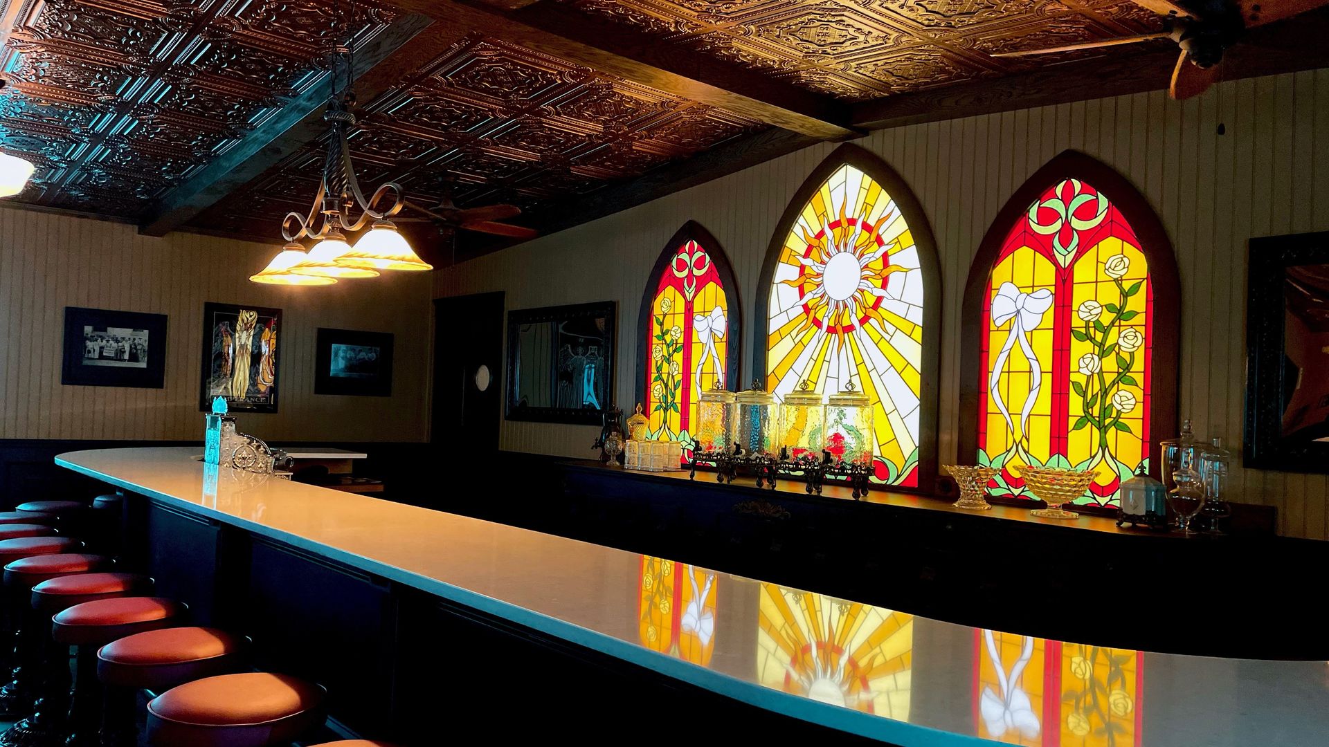 A bar with bright stained glass windows.