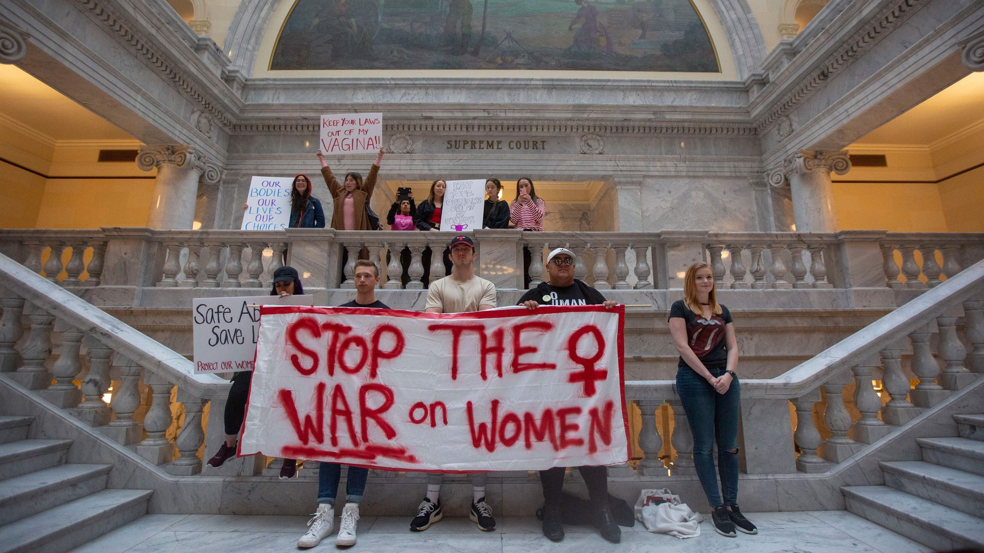Protesters hold signs at a rally to oppose abortion bans and increased restrictions happening throughout the United States, at the State Capitol Building in Salt Lake City, Utah on May 21, 2019. 