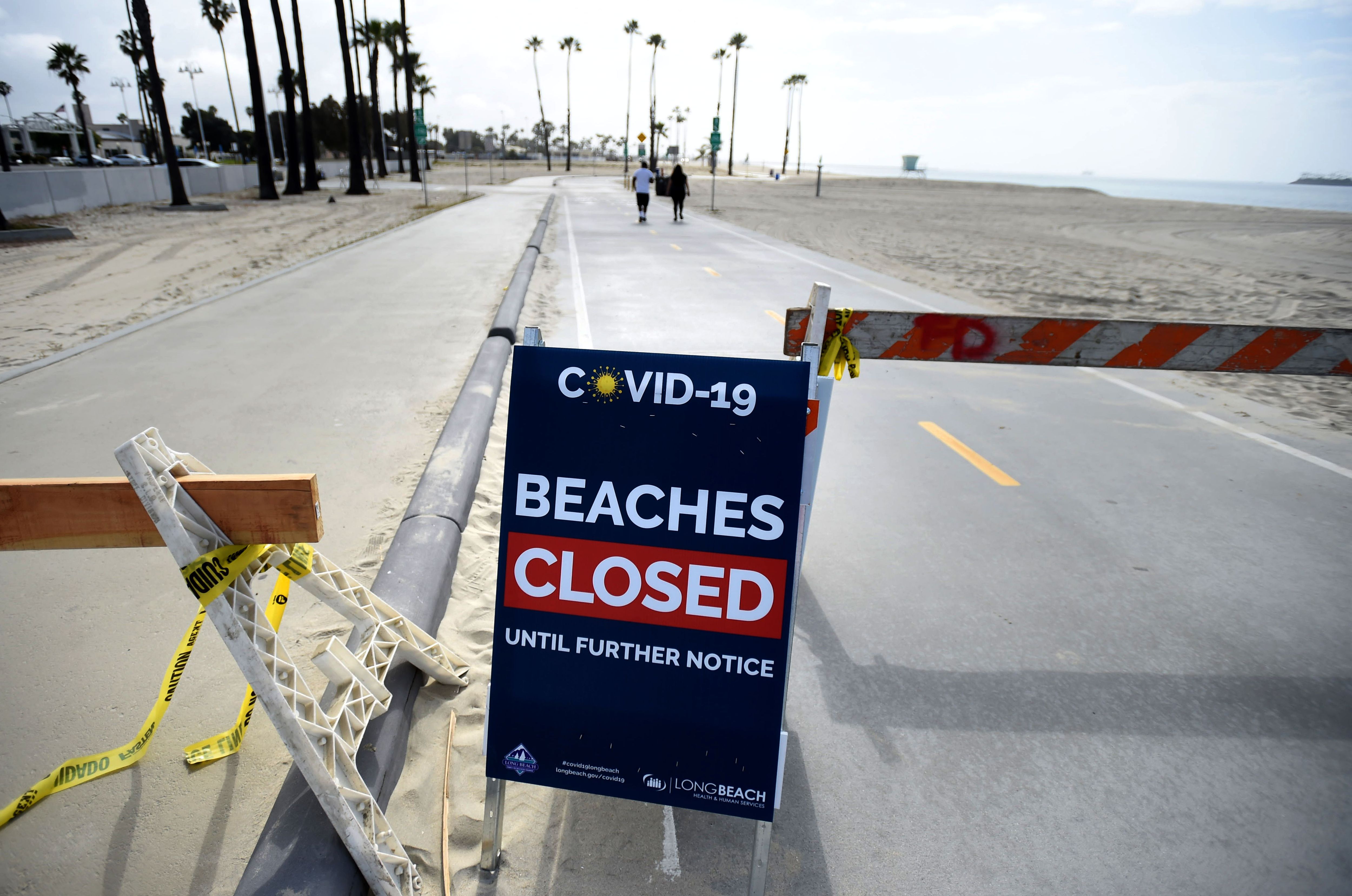 Signs are posted throughout the city reminding residents of what areas are closed due to the coronavirus in Long Beach 
