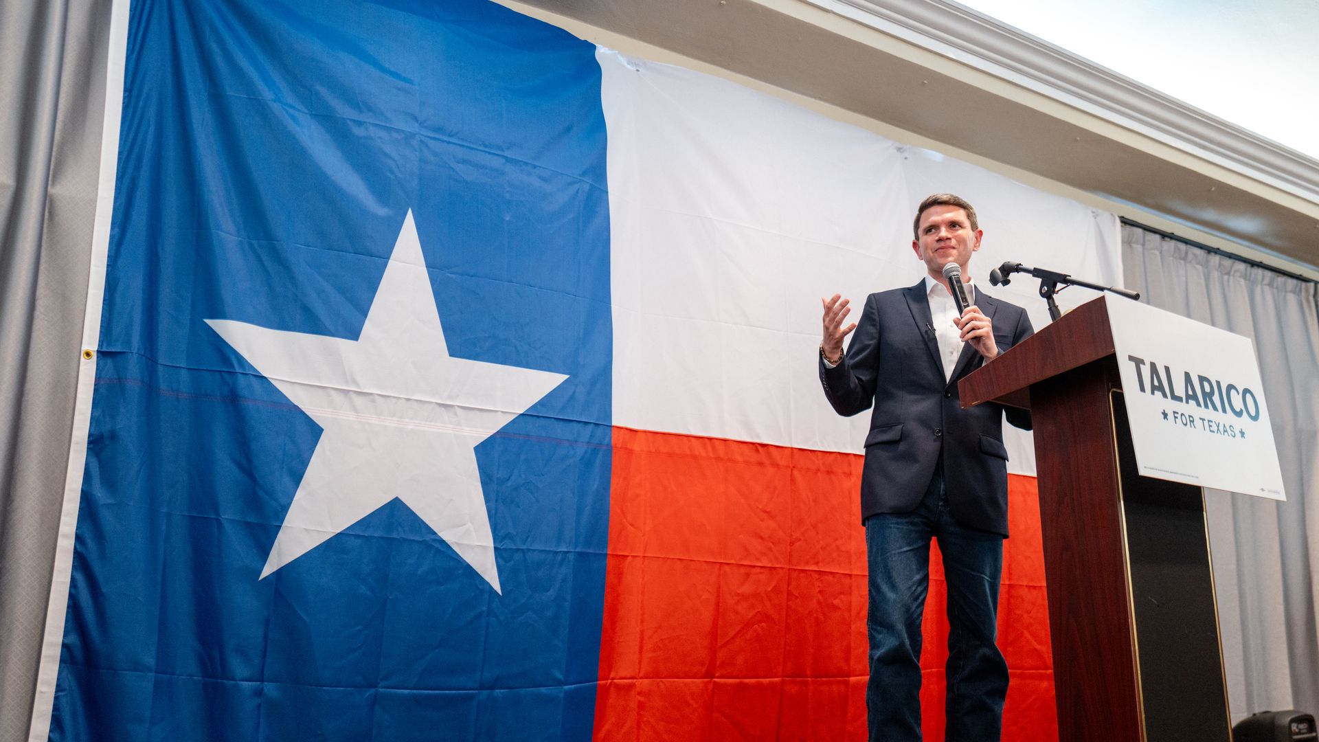 James Talarico in front a a big Texas state flag