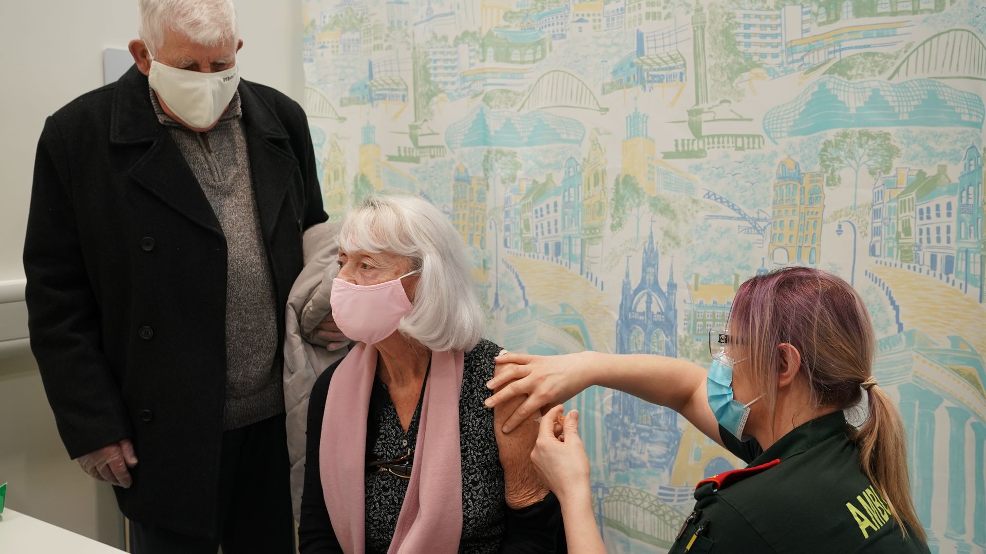 Picture of an old woman getting vaccinated for coronavirus in the U.K.