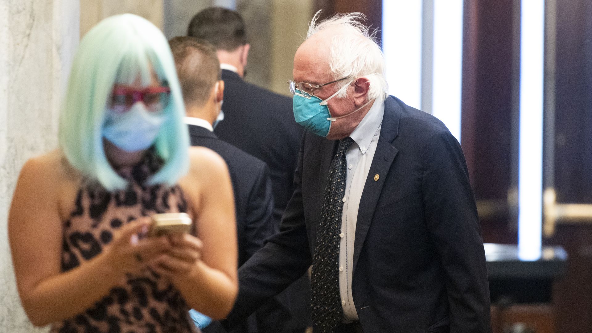 Sens. Bernie Sanders and Kyrsten Sinema are seen in the U.S. Capitol.