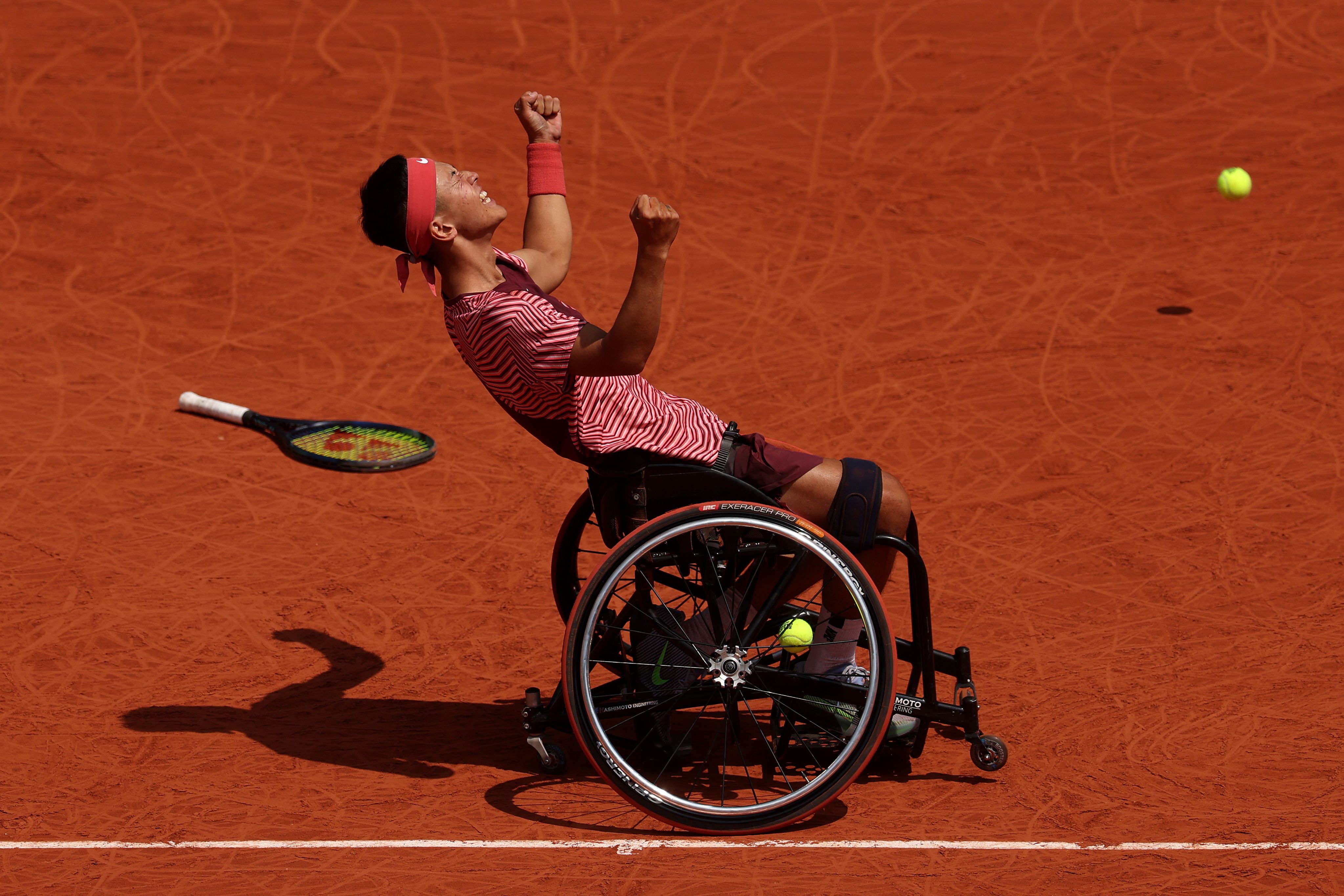 wheelchair tennis player celebrates