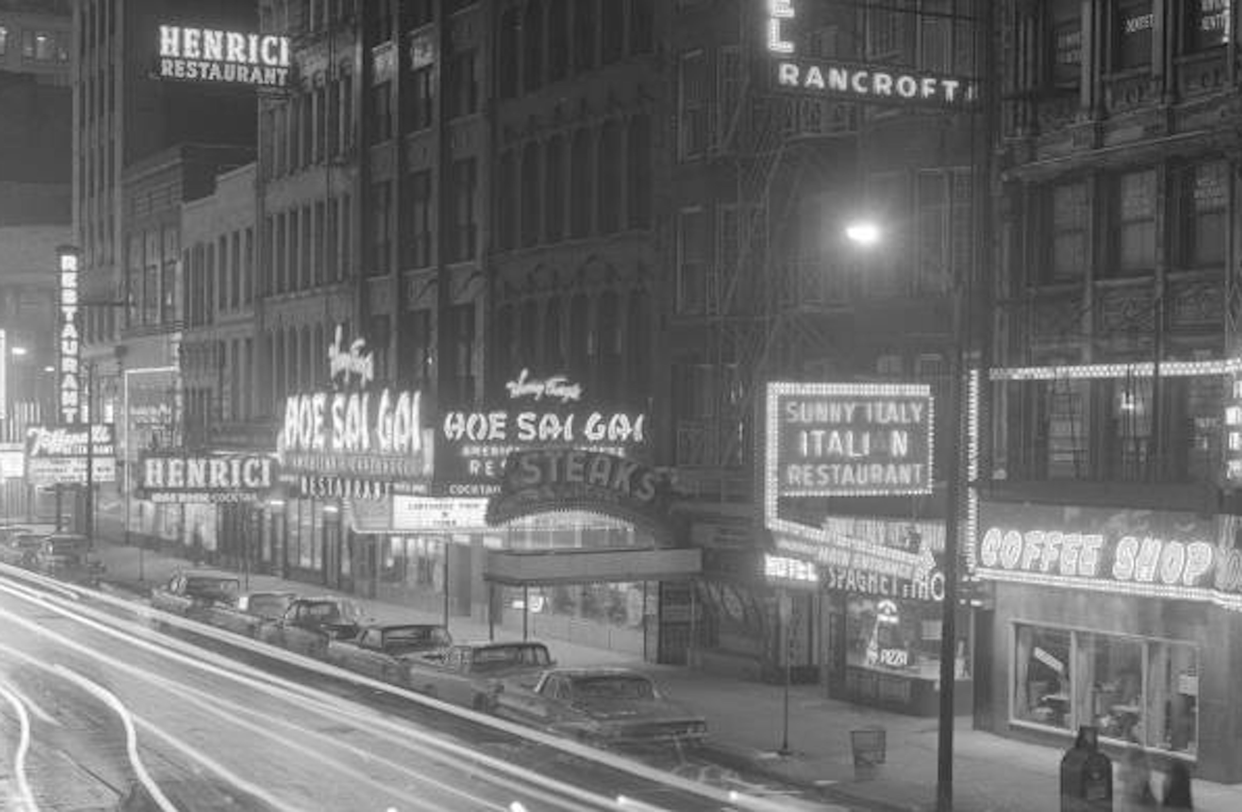 Photo of a restaurant row with neon signs