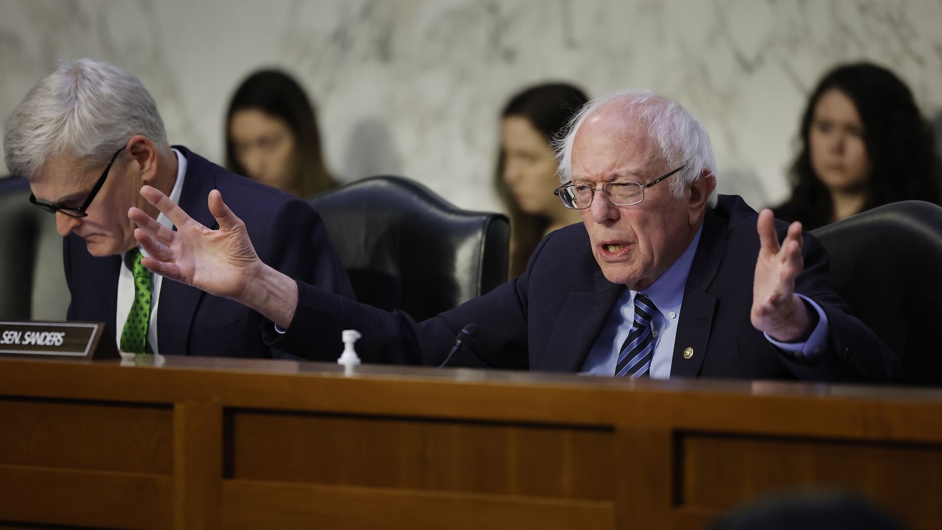 Senator Bernie Sanders gestures as Senator Bill Cassidy listens at a HELP Committee hearing