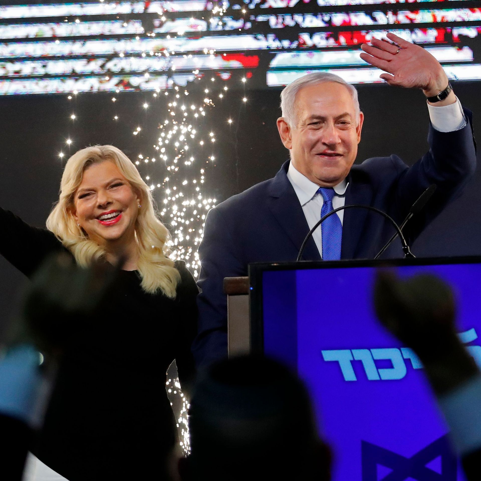 Benjamin Netanyahu and his wife, Sara, on stage before supporters