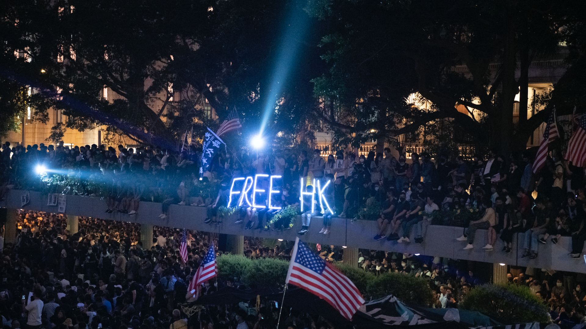 Protesters are seen holding up American Flags and a Free HK sign during a Rally in Hong Kong