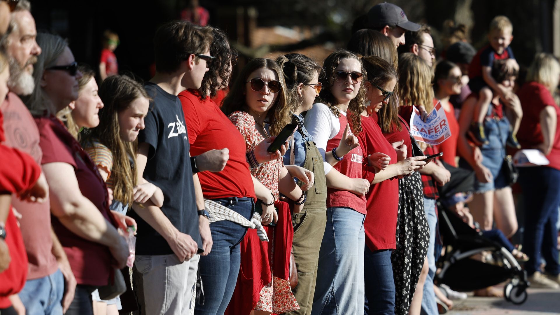 Protestors participate in a demonstration of linking arms in support of gun control laws