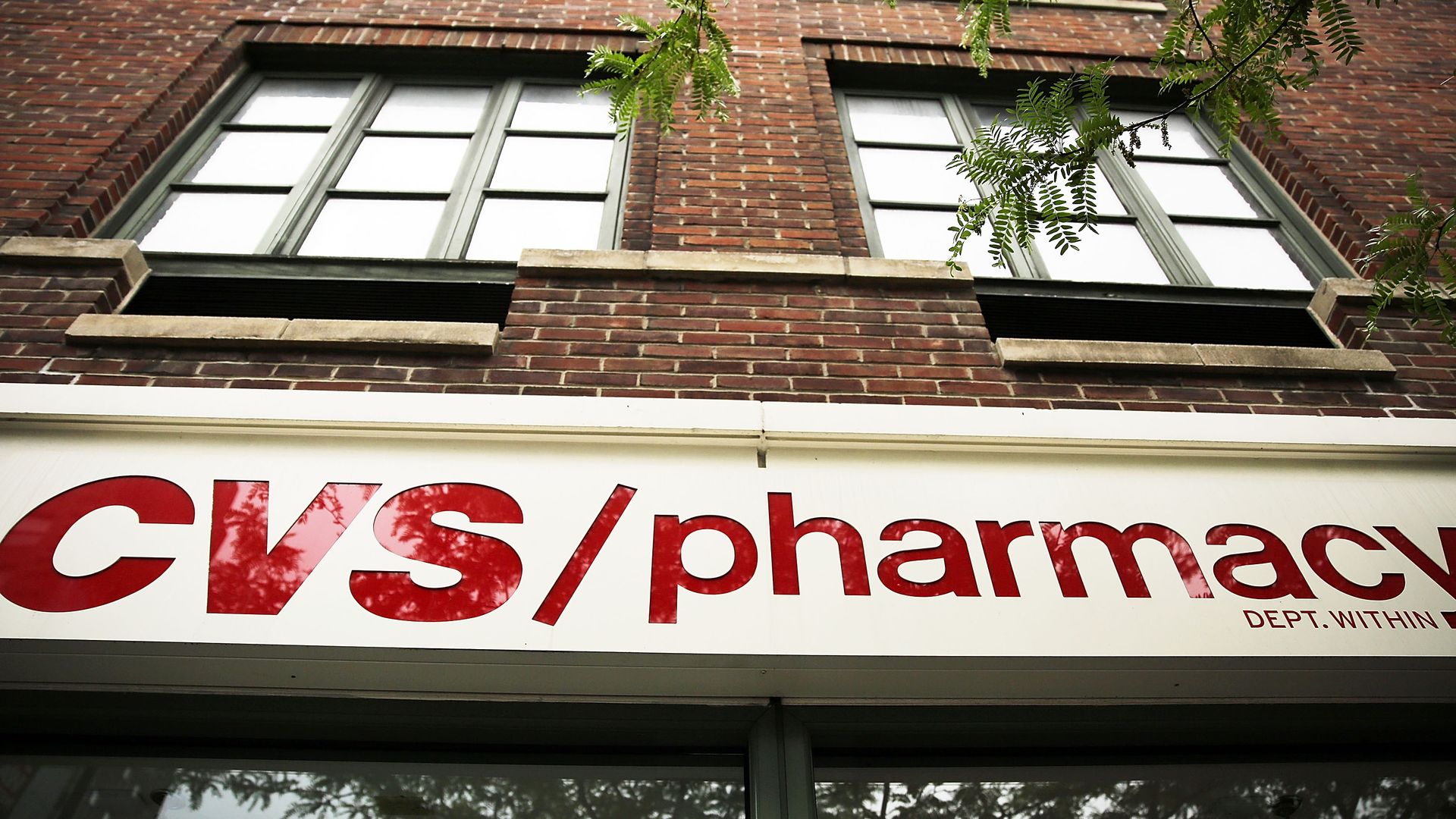 The CVS pharmacy logo on a storefront.