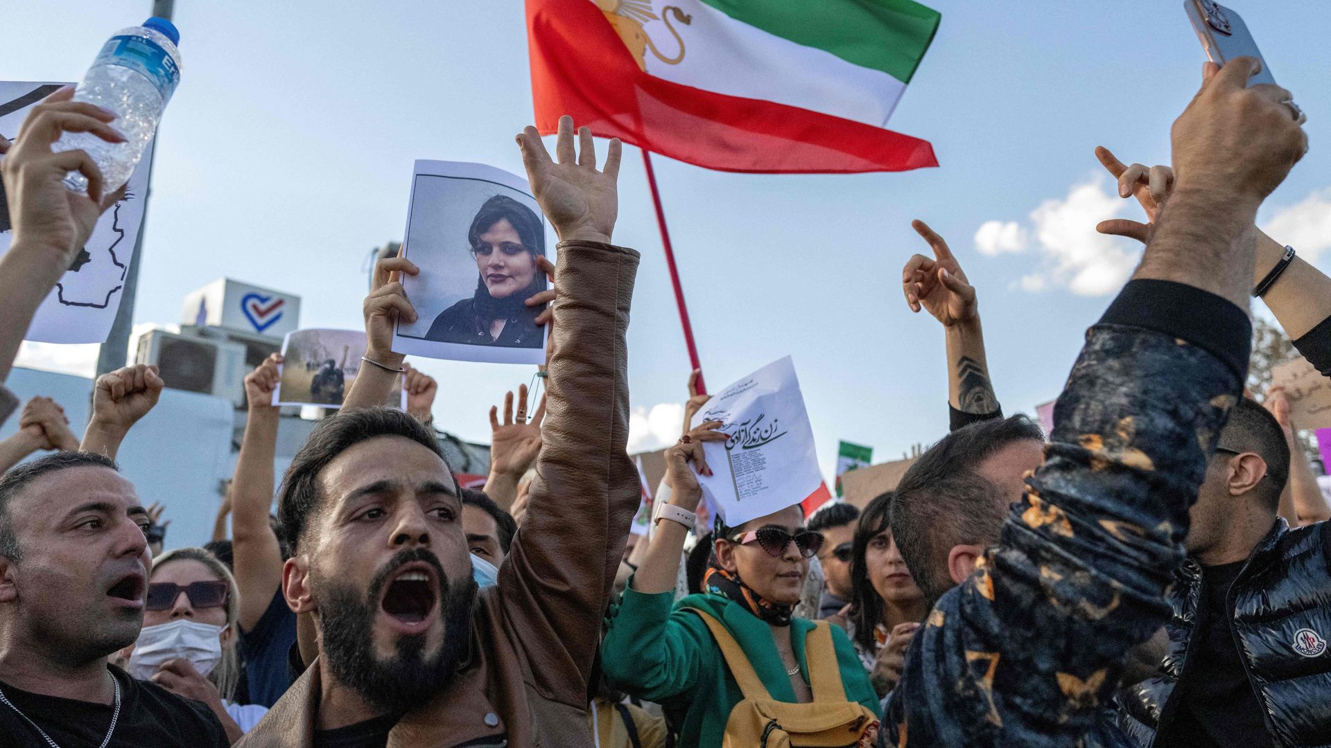 A protestors holds a photo of Kurdish Iranian woman Mahsa Amini