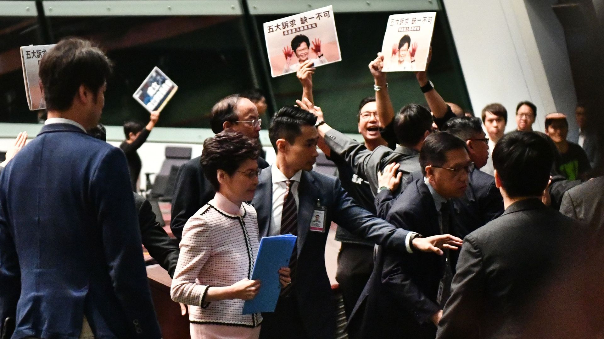 Hong Kong's Chief Executive Carrie Lam leaves the chamber after trying to give her annual policy address