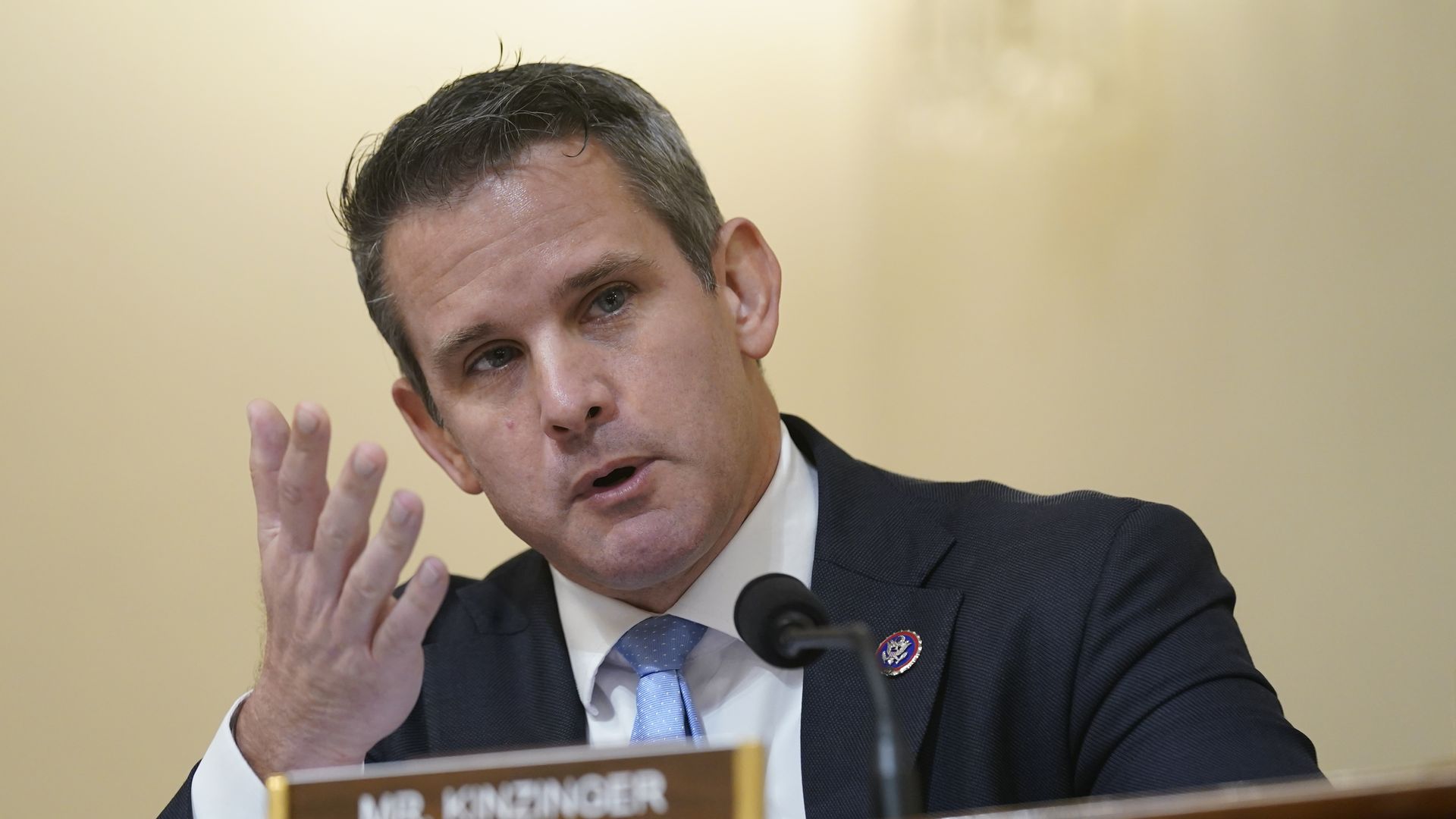Photo of Adam Kinzinger speaking with one hand raised