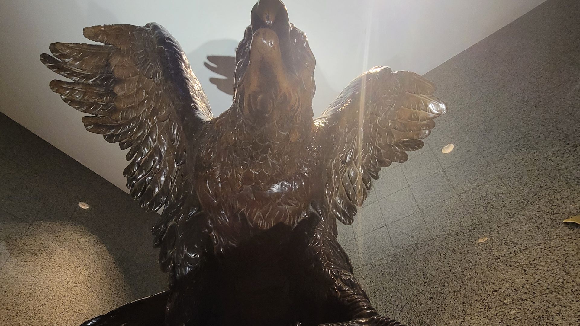 A bronze eagle statue inside a building. Do you know where Axios reporter Isaac Avilucea is?