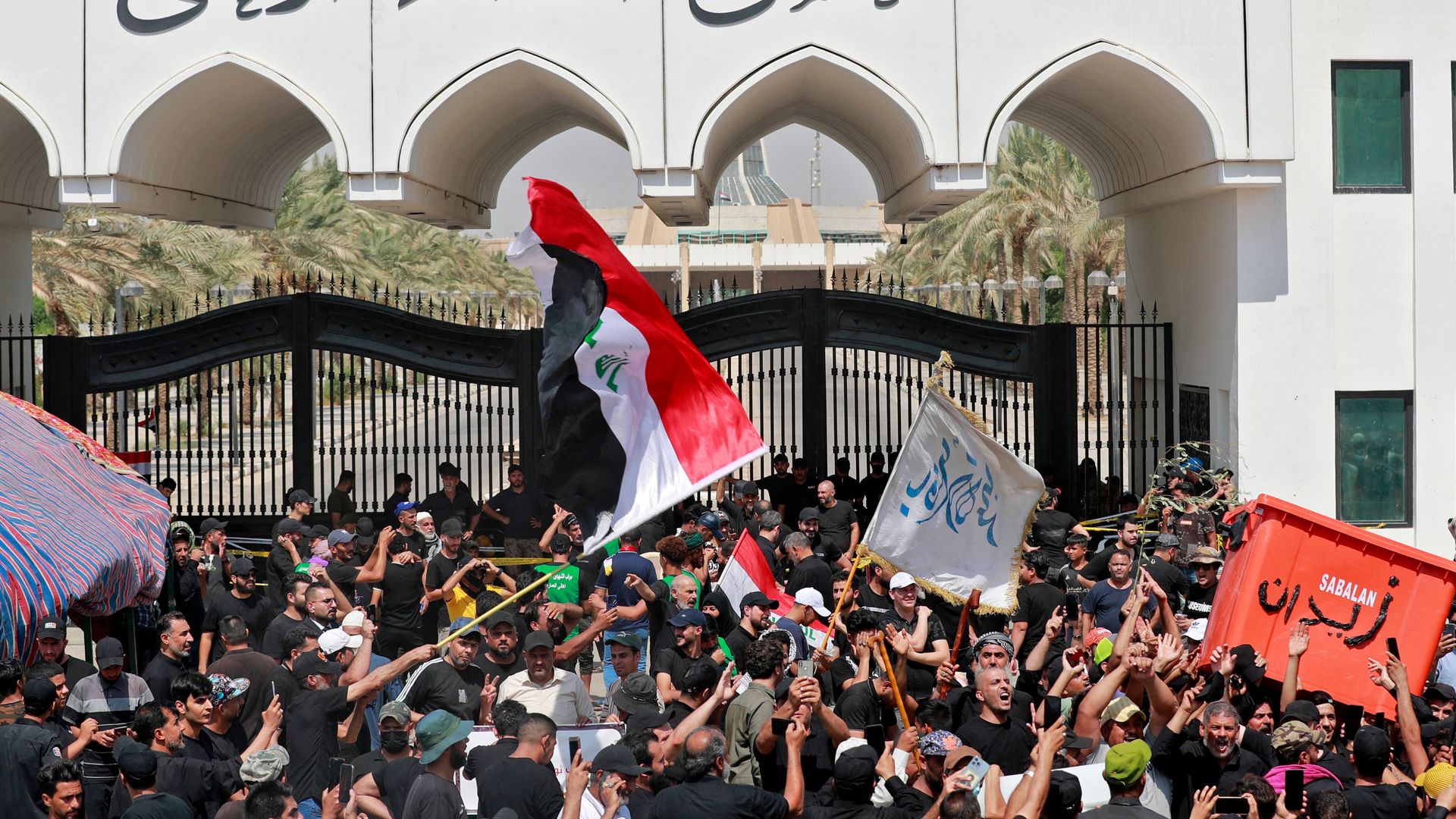 Supporters of Iraqi Muslim Shiite cleric Moqtada Sadr gather outside the headquarters of the Supreme Judicial Council on Aug. 23.