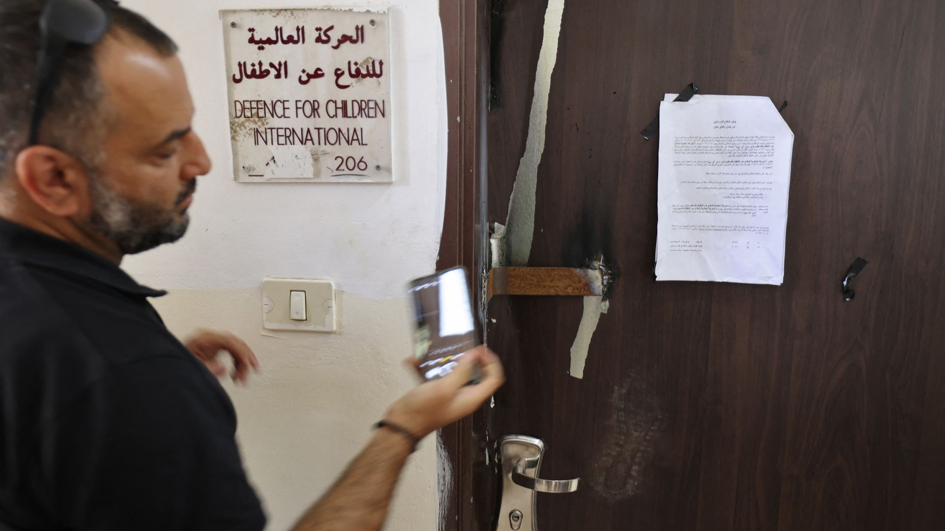 the closed door of Palestinian NGO Defence for Children International after it was raided by Israeli forces in the West Bank city of Ramallah