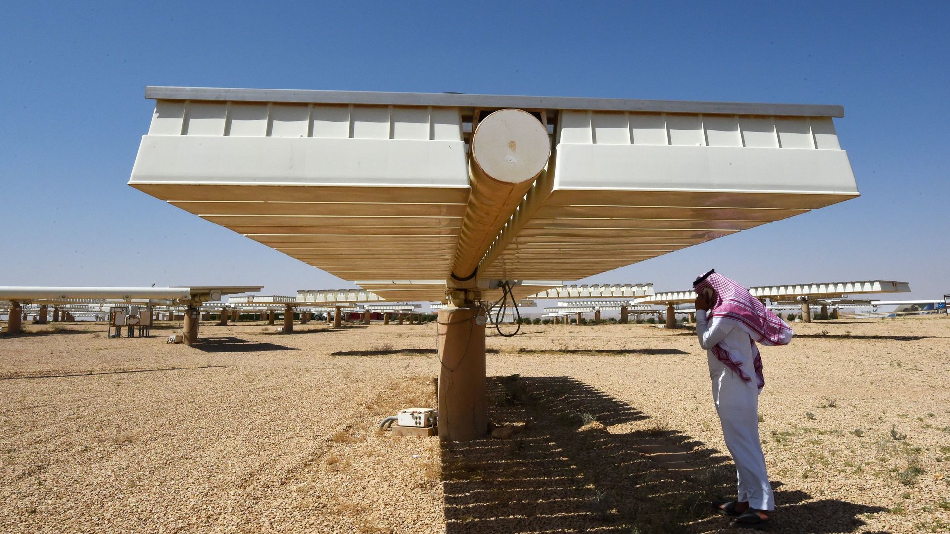 Saudi man talking on his cell phone at a solar plant