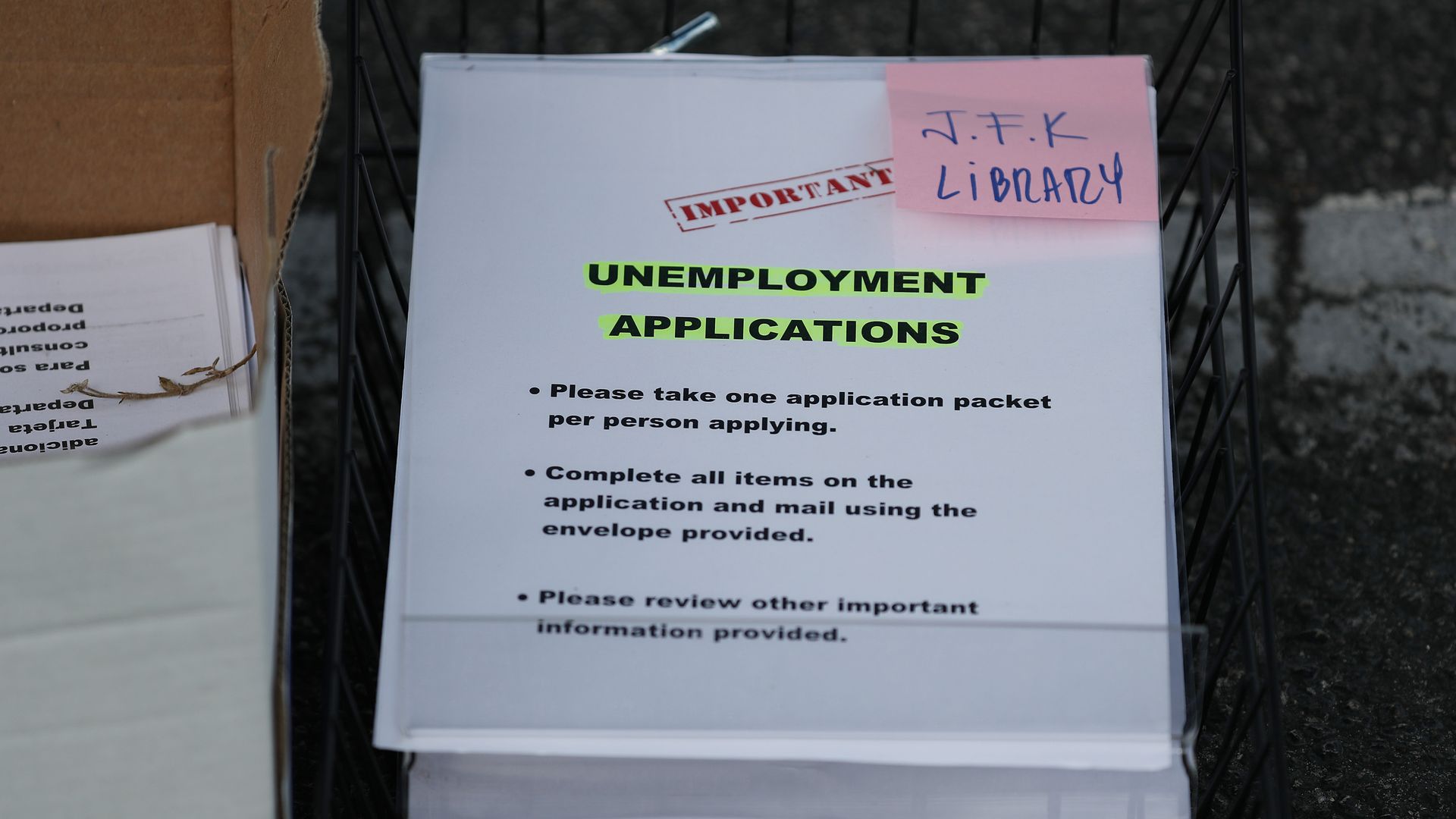 Unemployment applications are seen as Hialeah, Florida, employees hand them out to people in front of a library.