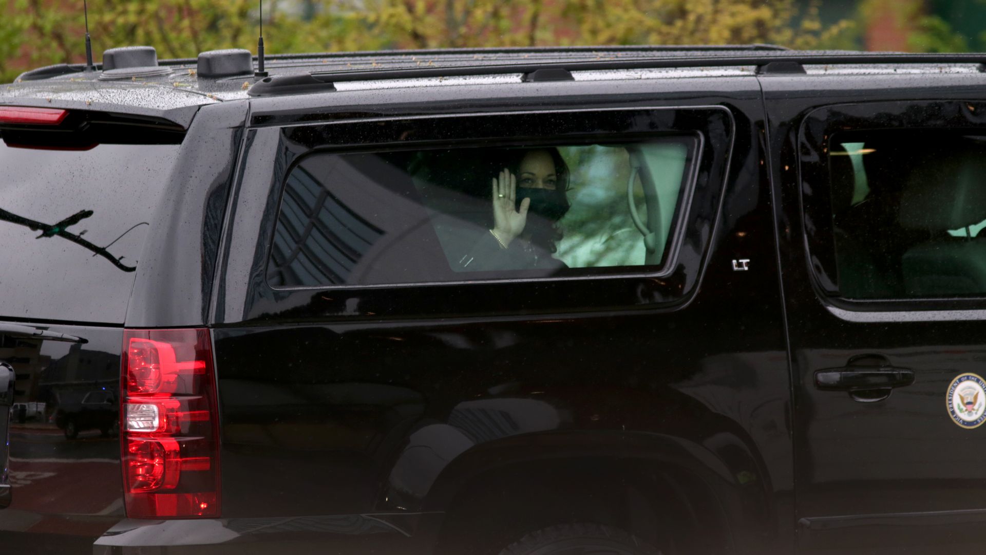 Vice President Kamala Harris is seen waving from her limousine during a visit to Rhode Island.