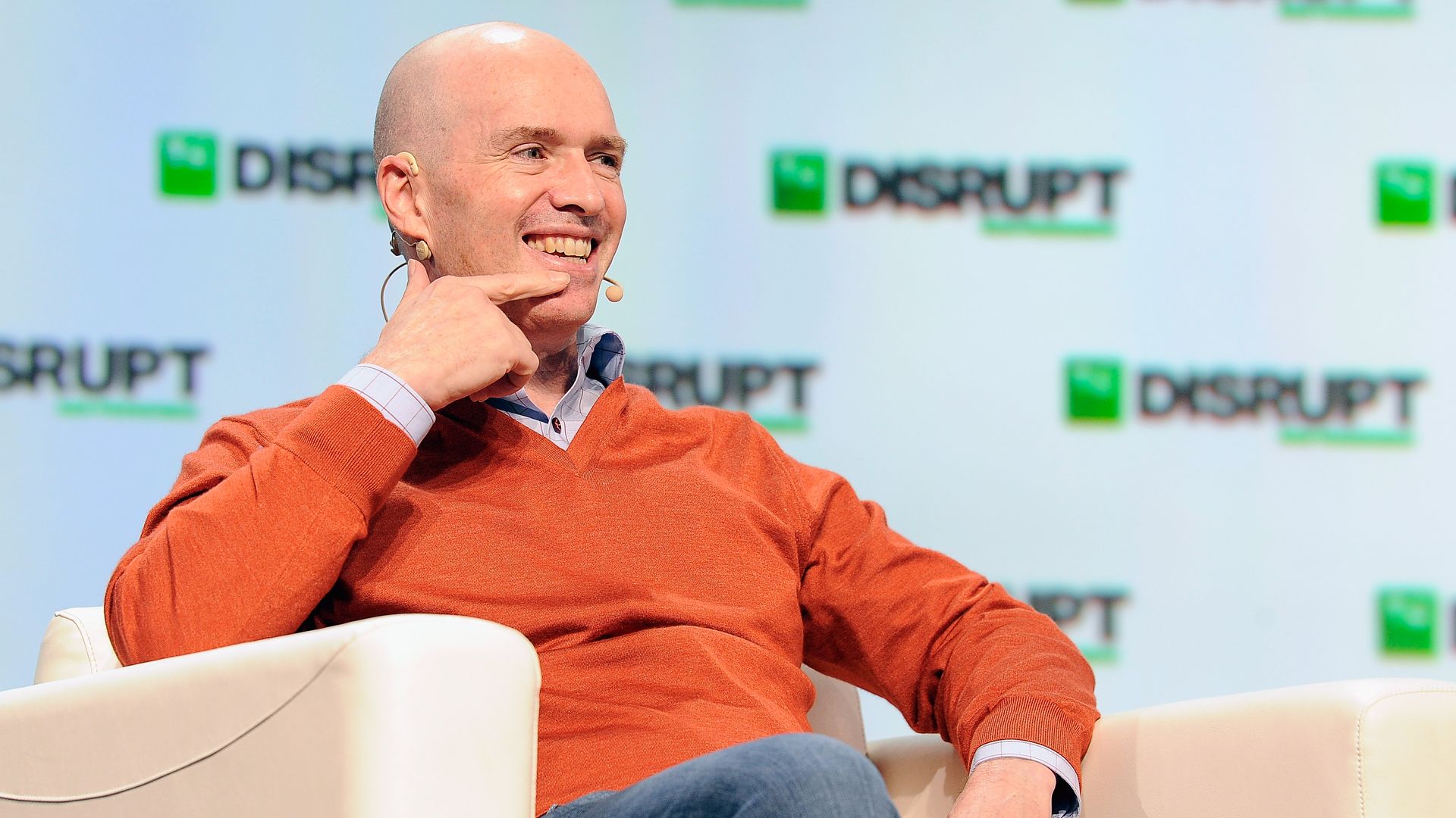 In this image, Andreessen Horowitz sits in a chair and speaks.