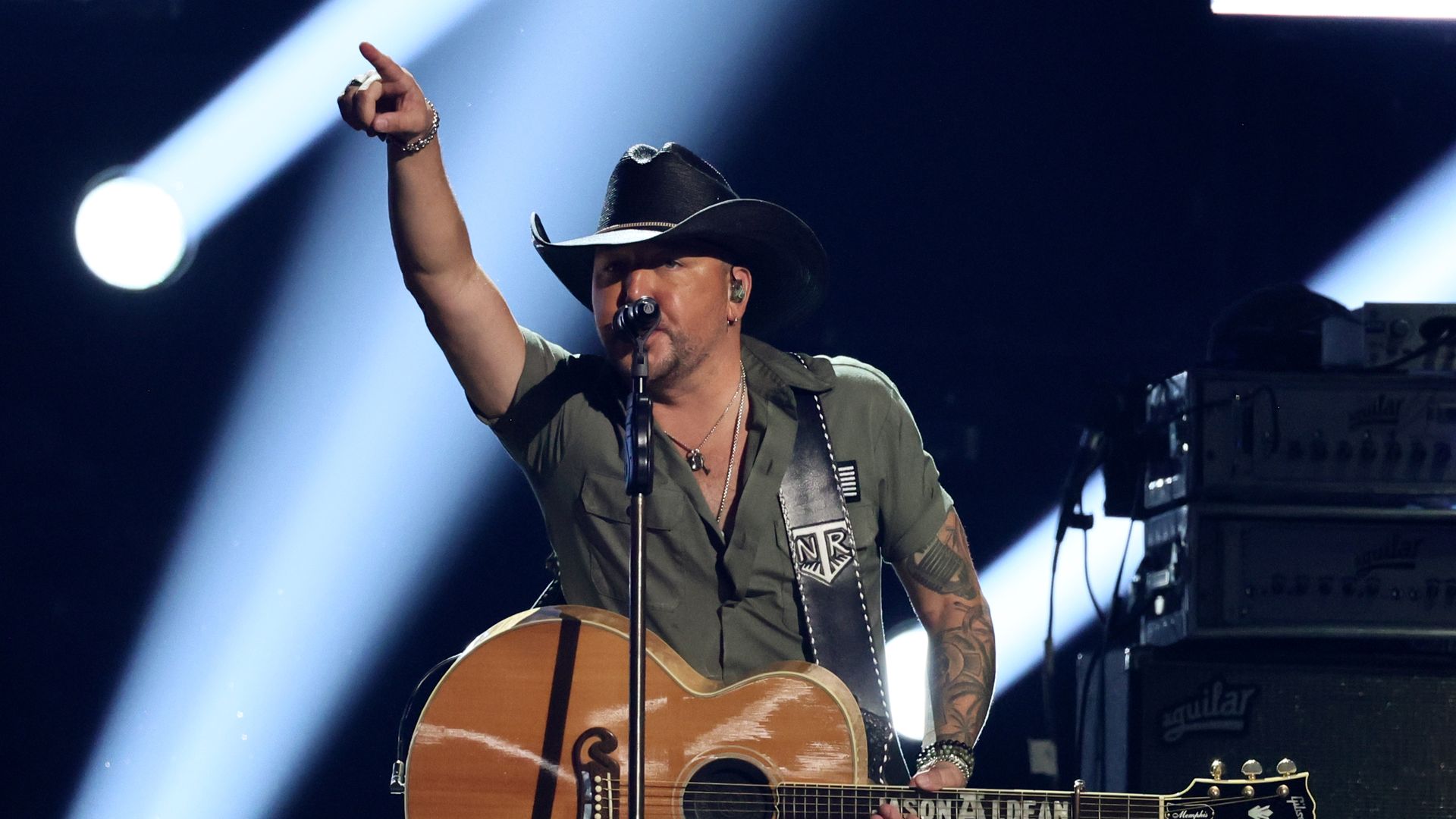 Country singer Jason Aldean points to the crowd as he performs on stage. 