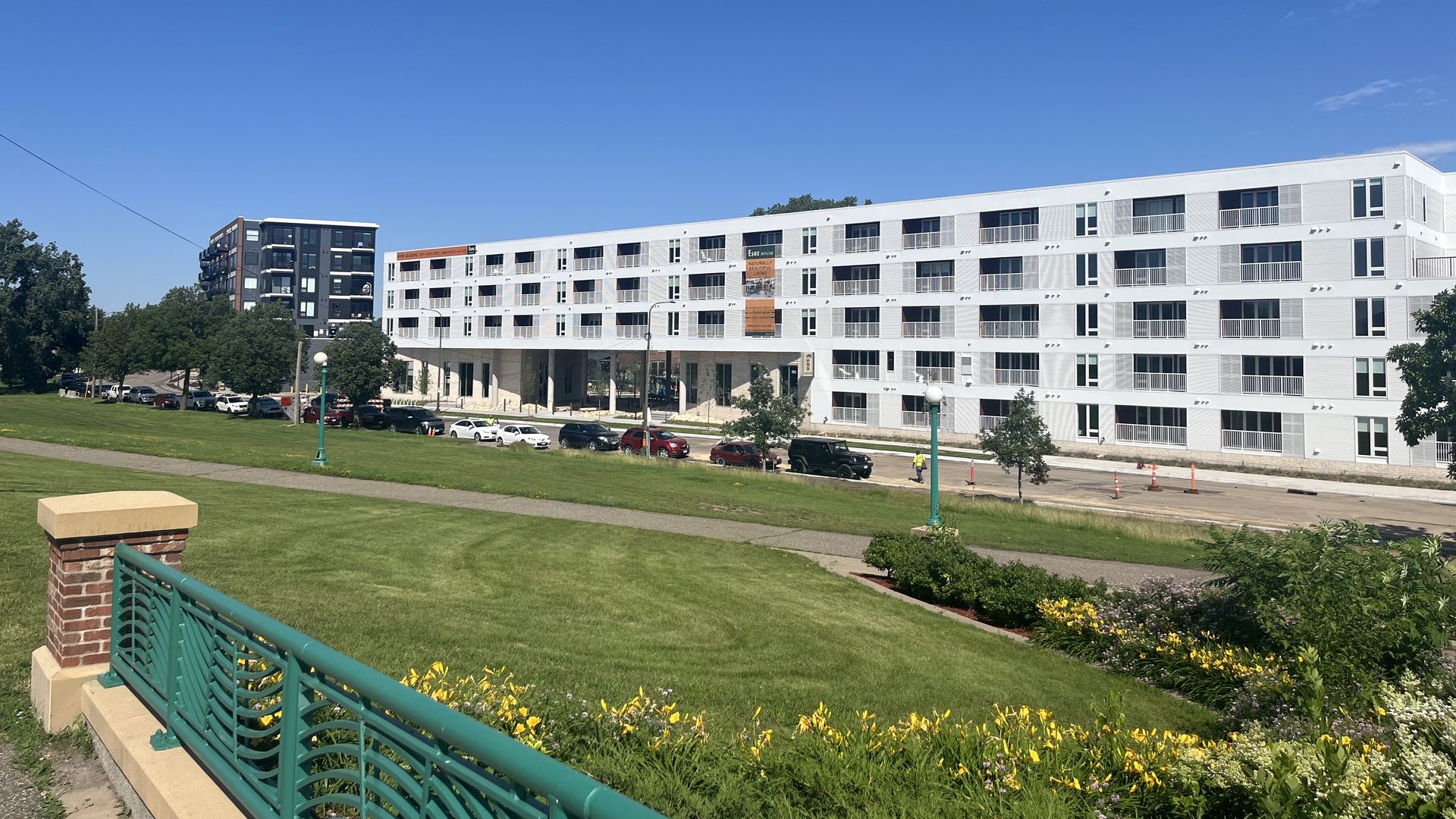 A white apartment building on the other side a levy