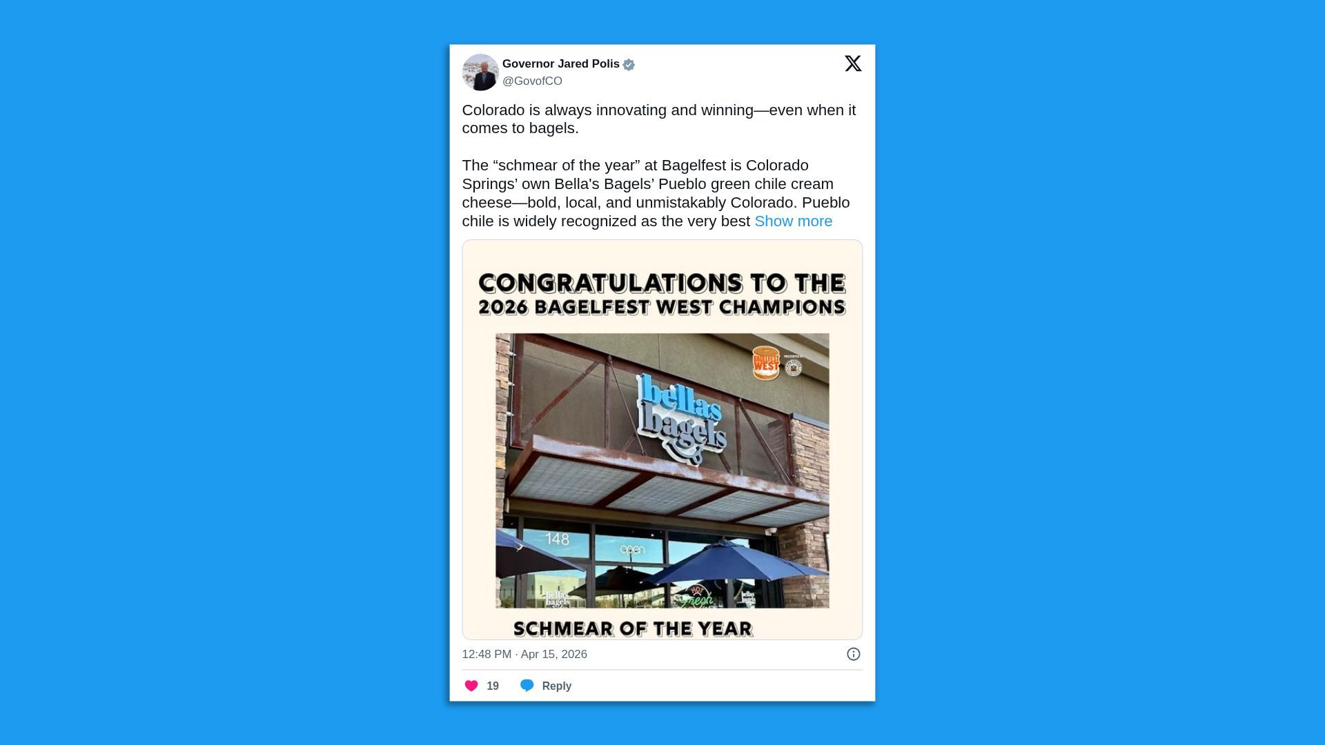 Post by Governor Jared Polis praising Colorado bagels; shows a Bellas Bagels storefront with a beige border and the banner "CONGRATULATIONS TO THE 2026 BAGELFEST WEST CHAMPIONS" above the shop.