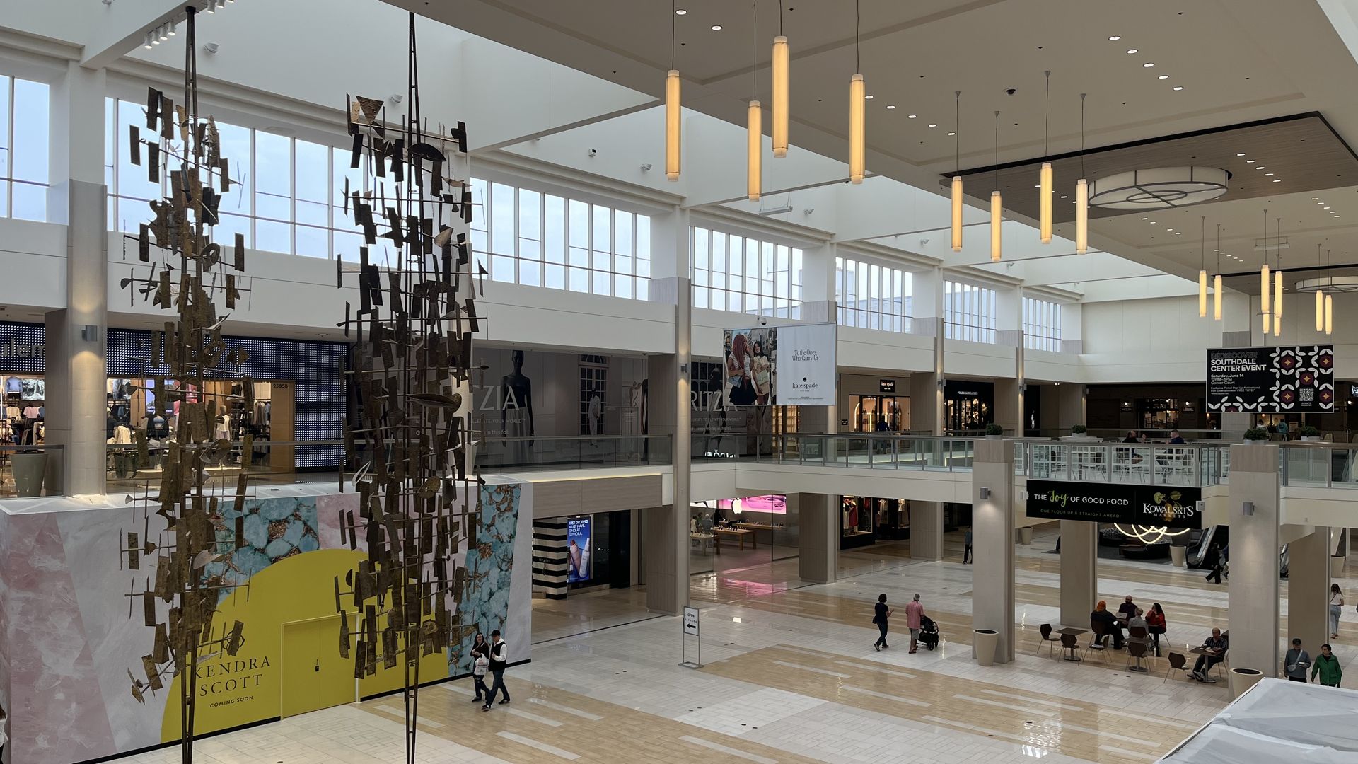 A photo showing the inside of Southdale Center with two large hanging sculpture  