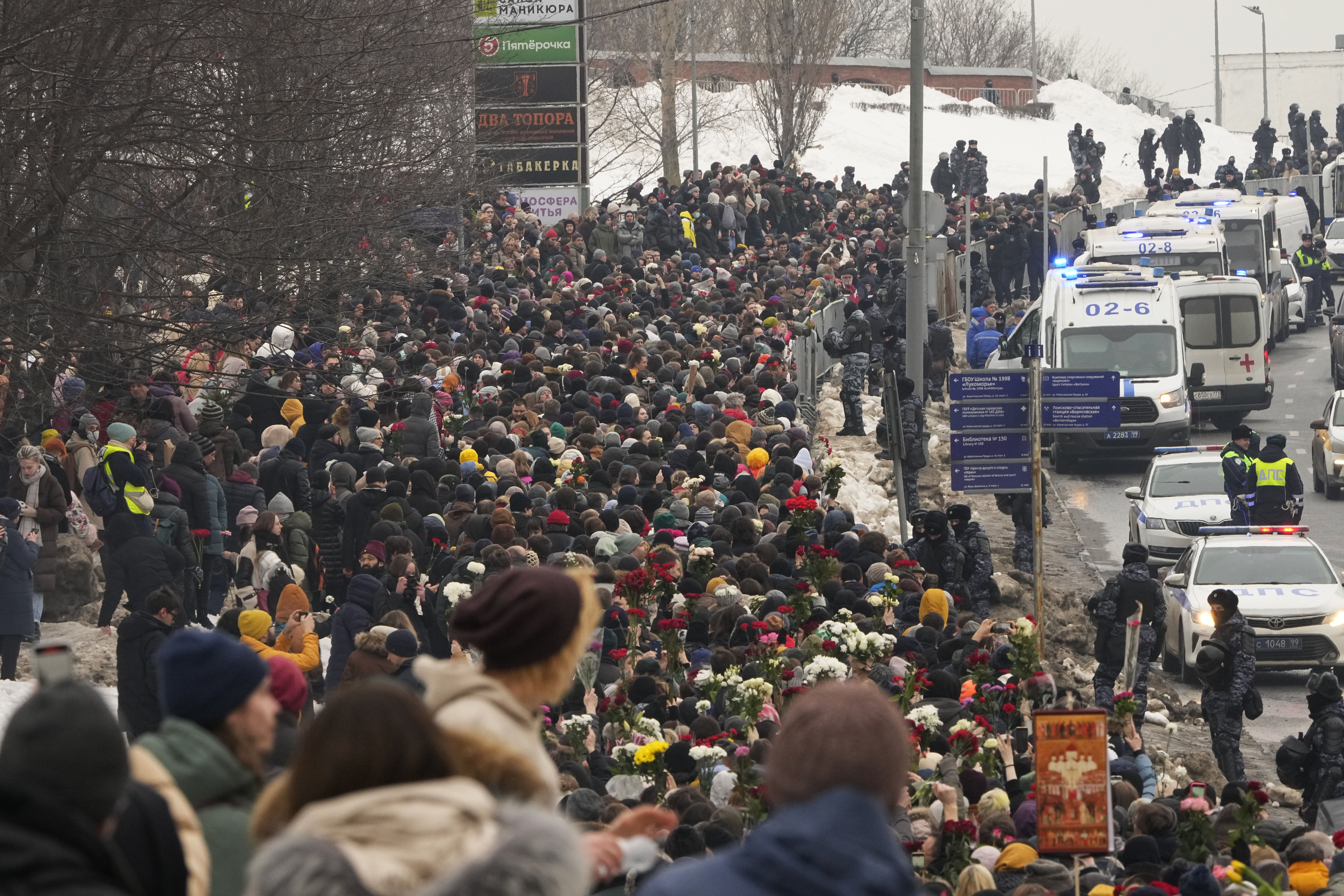 Police, right, observe as people walk towards the Borisovskoye Cemetery for the funeral ceremony of Russian opposition leader Alexei Navalny, in Moscow, Russia, Friday, March 1, 2024. Under a heavy police presence, thousands of people bade farewell Friday to Alexei Navalny at his funeral in Moscow after his still-unexplained death two weeks ago in an Arctic penal colony. (AP Photo)