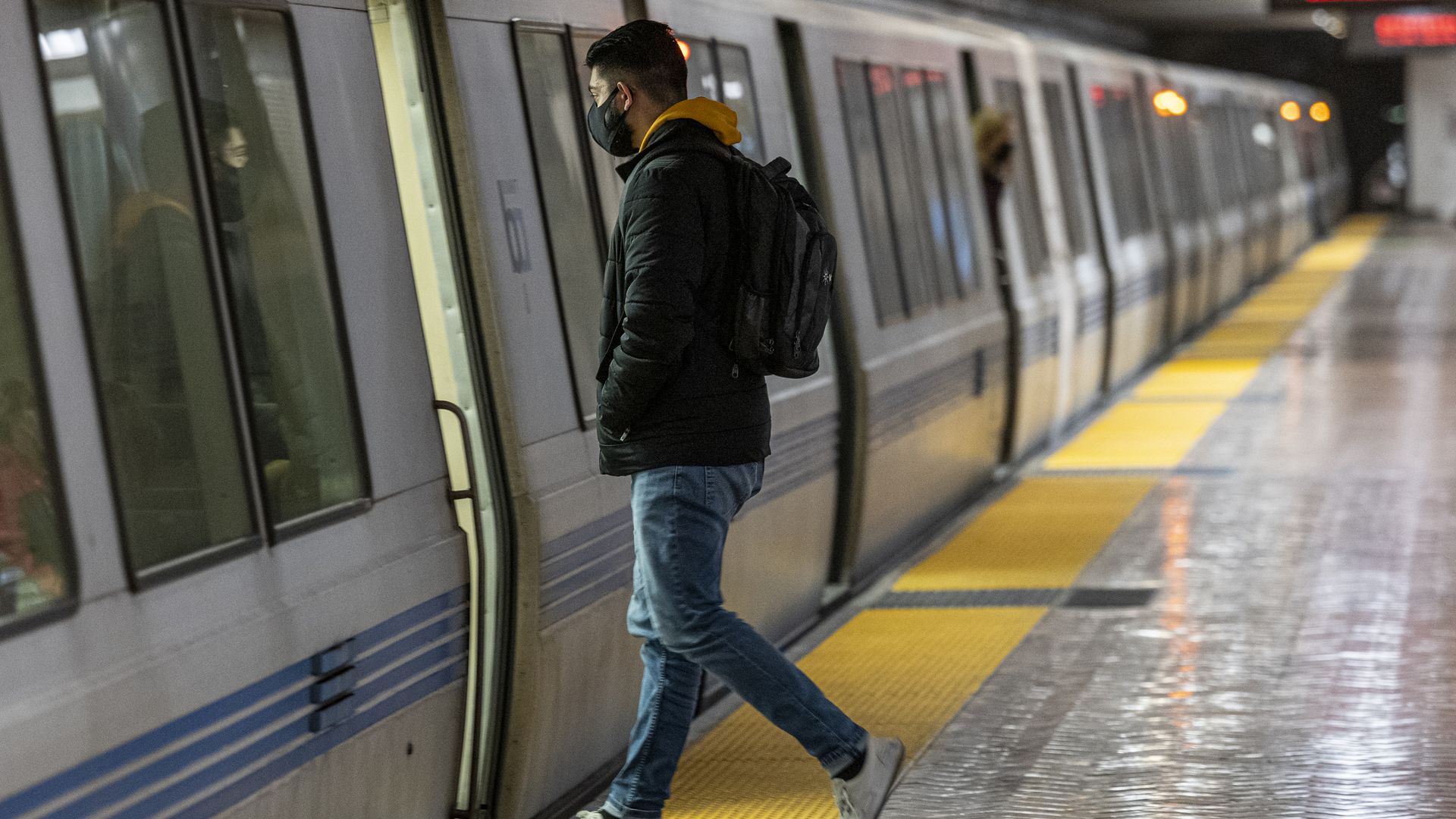 A commuter boards a Bay Area Rapid Transit (BART) train in the New Montgomery station in San Francisco, California, U.S., on Friday, March 4, 2022.