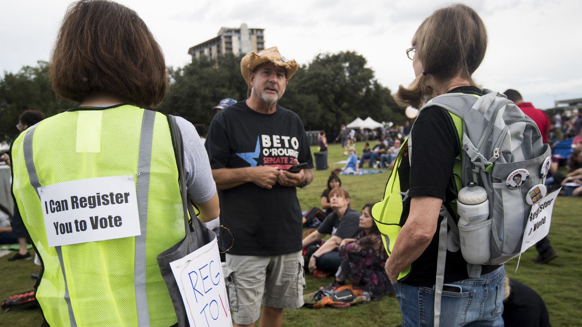 Campaign volunteers work the crowd to register supporters to vote before the start of a political rally in 2018.