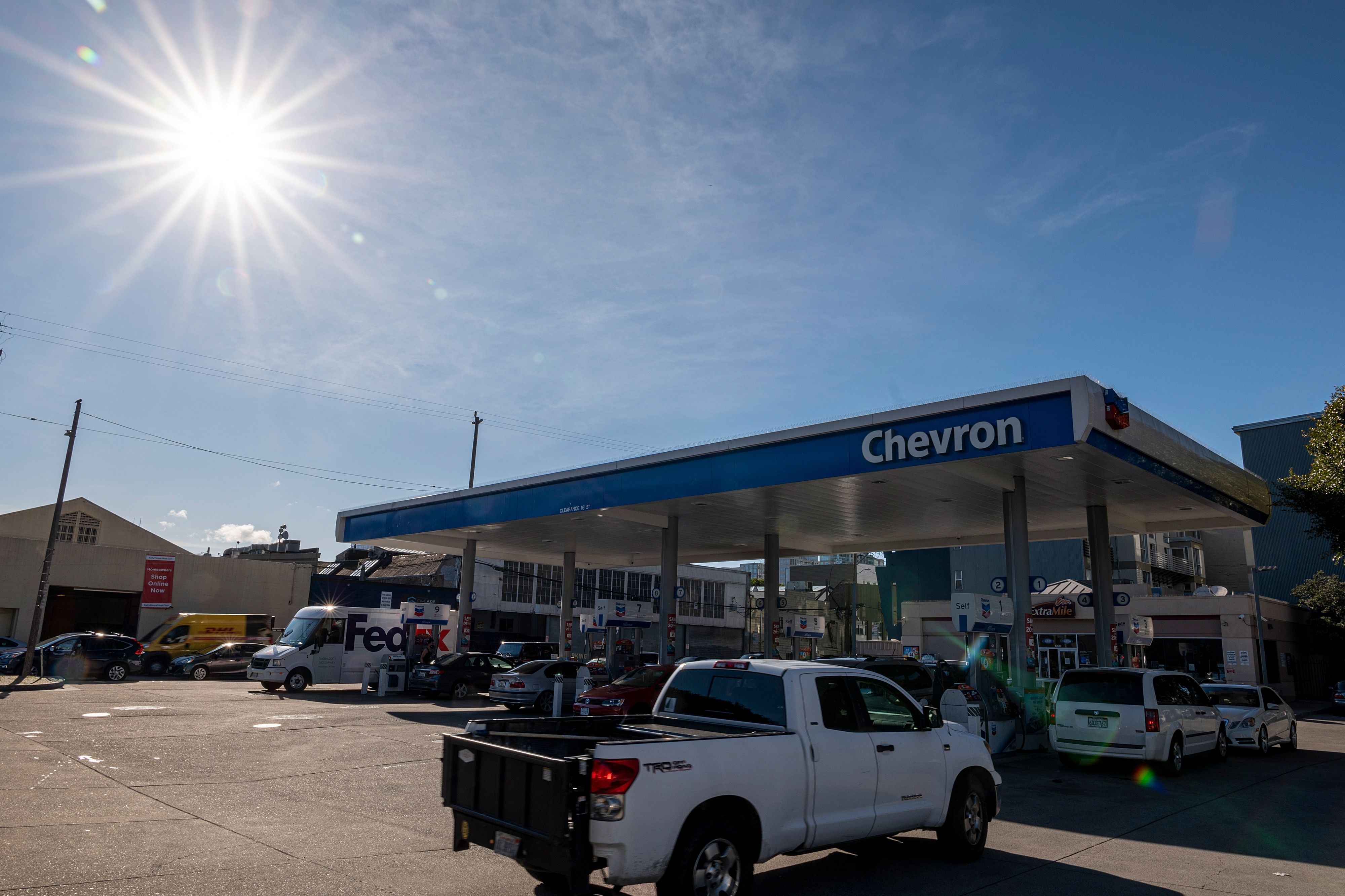 Cars line up at a Chevron Corp. gas station in San Francisco, California, U.S., on Thursday, March 11