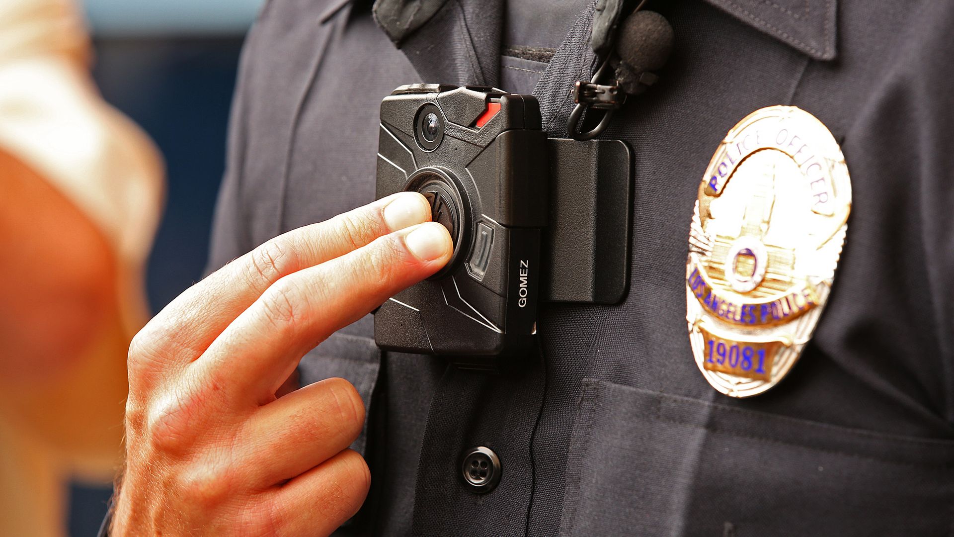 A photo of an officer turning on their body camera.