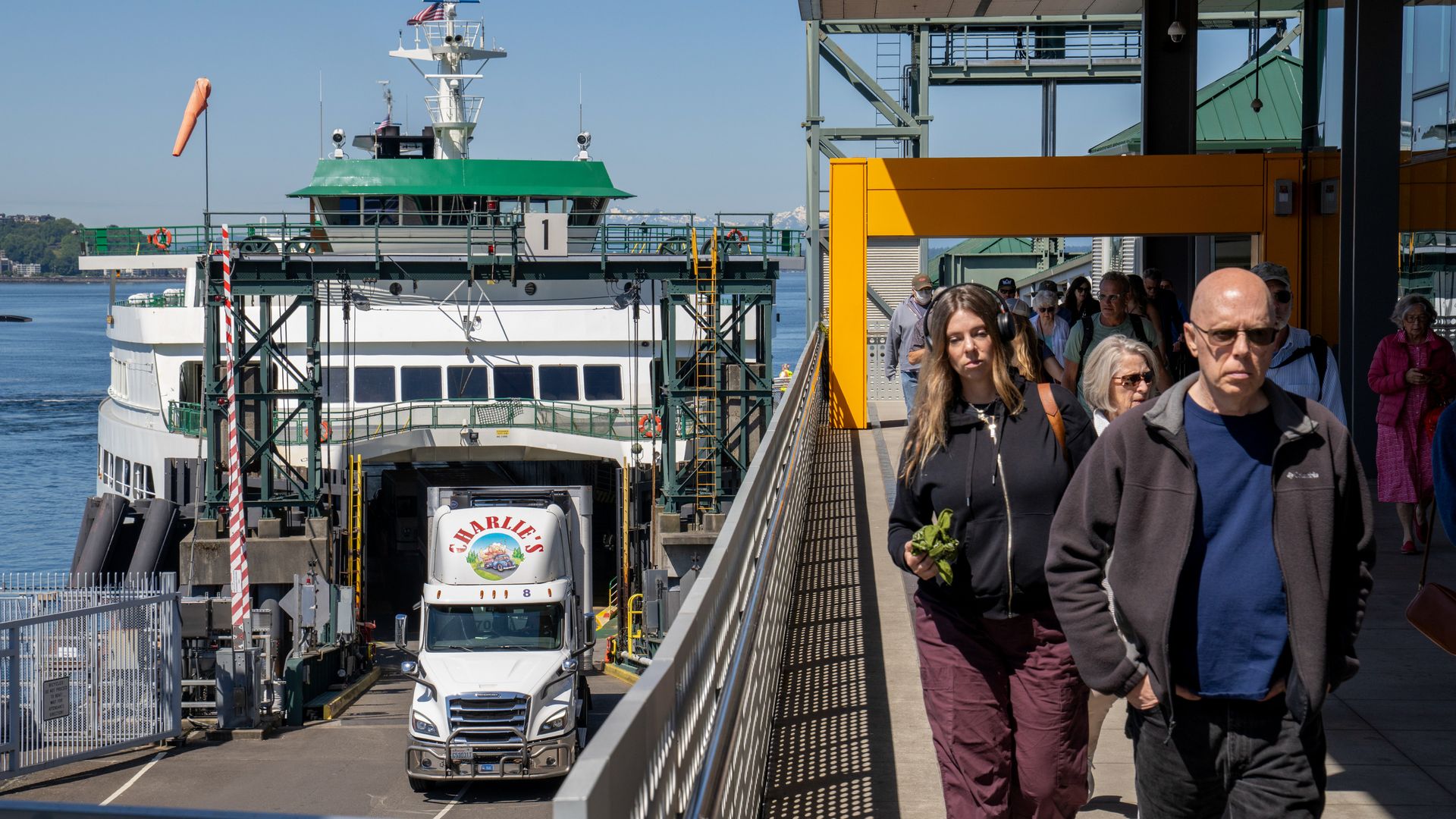 Passengers exit a ferry at the terminal in Seattle. 