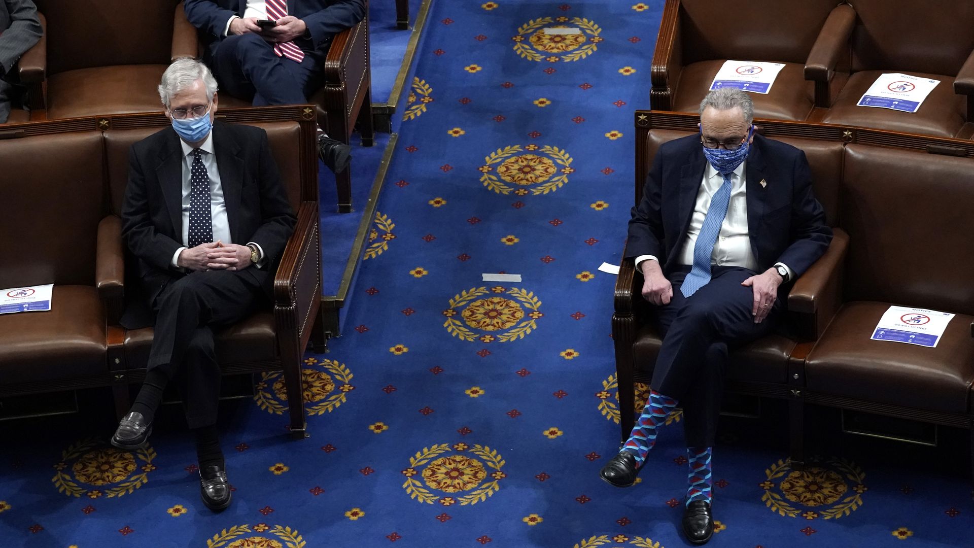 Mitch McConnell and Chuck Schumer are seen sitting across from one another as the Senate resumed work after the Capitol siege.
