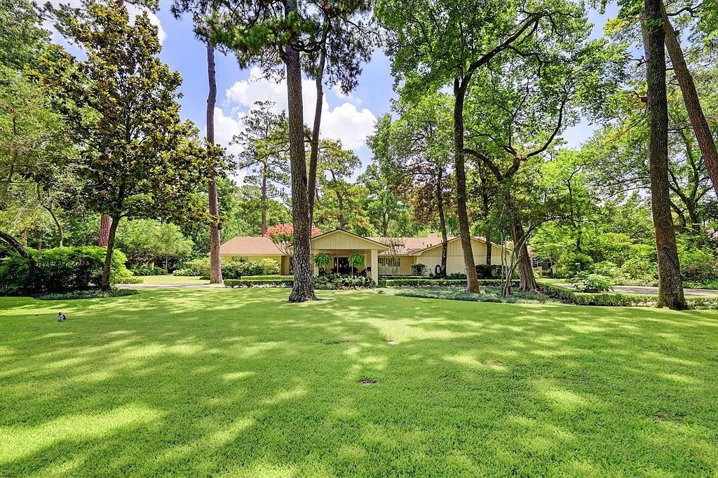 Photo of a yellow house in the woods. 