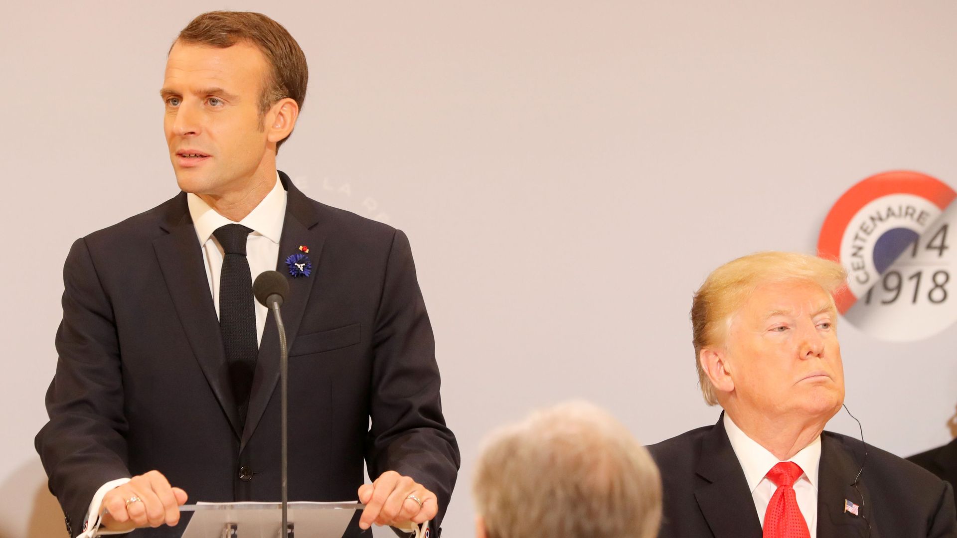 Photo of Trump and Macron looking in opposite directions.