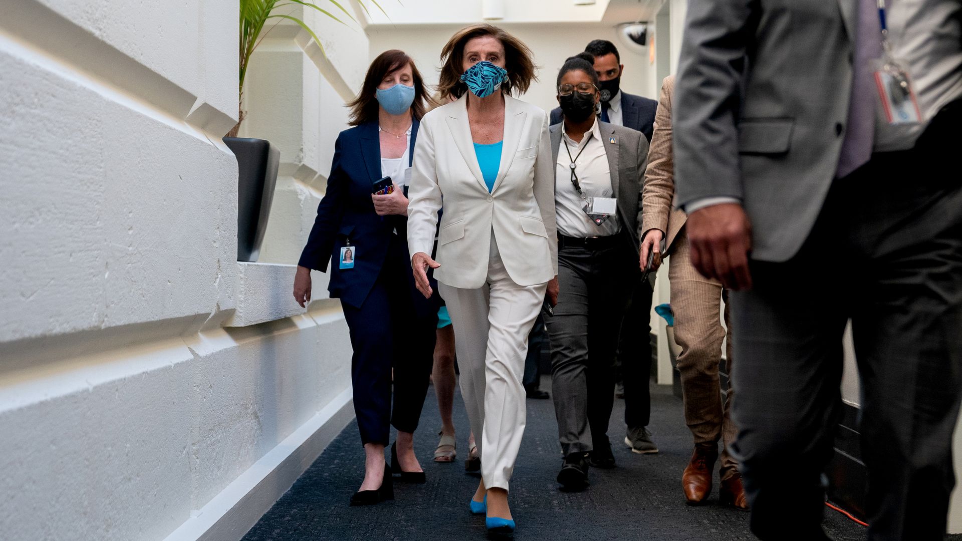 U.S. House Speaker Nancy Pelosi, a Democrat from California, center, departs the House Democratic Caucus meeting