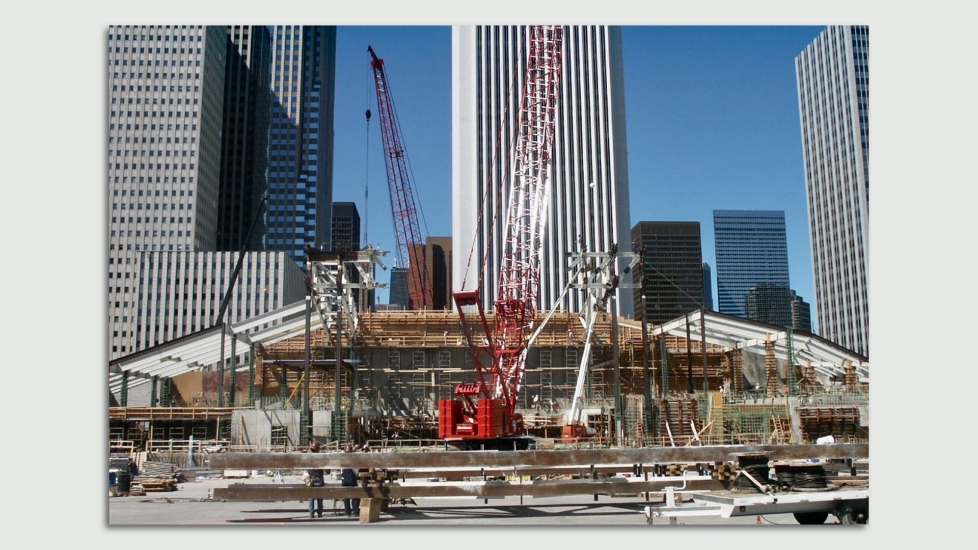 Construction site with a red crane in front of Chicago's Aon building.