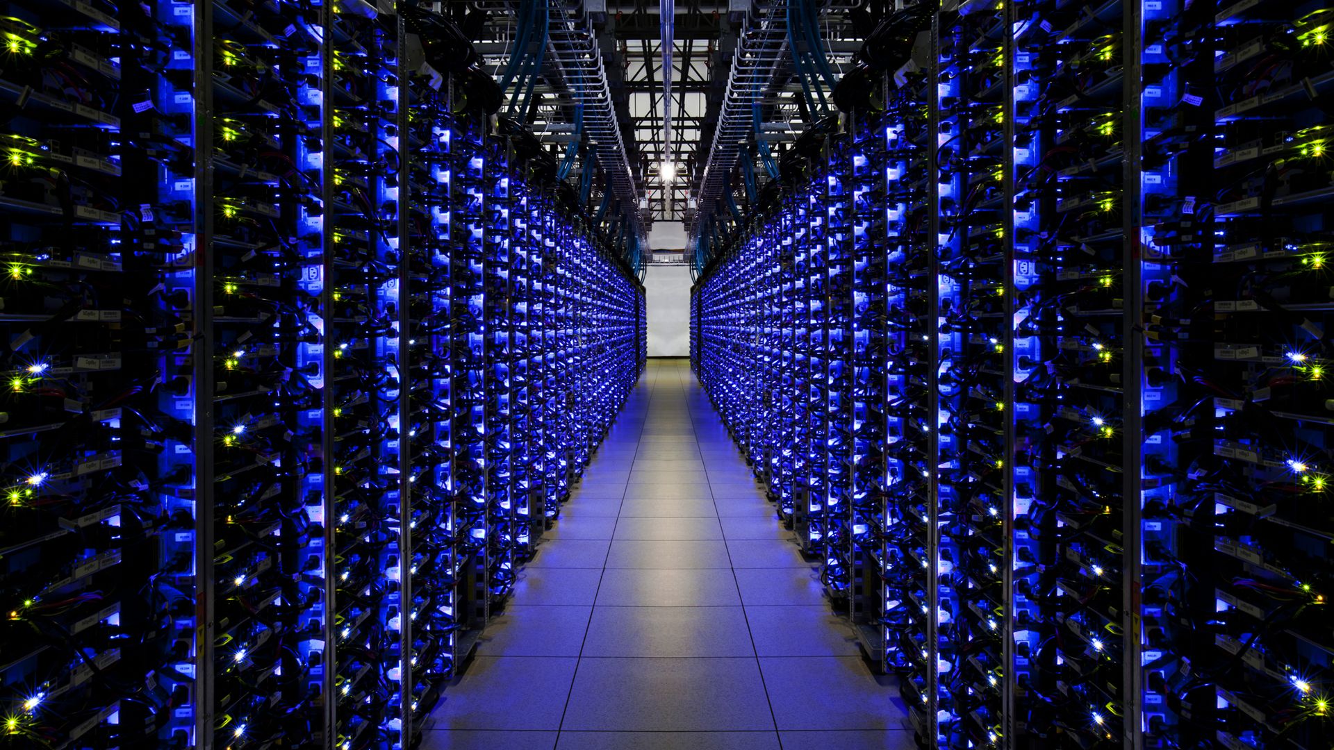 Inside of a Google data center lit up by blue lights