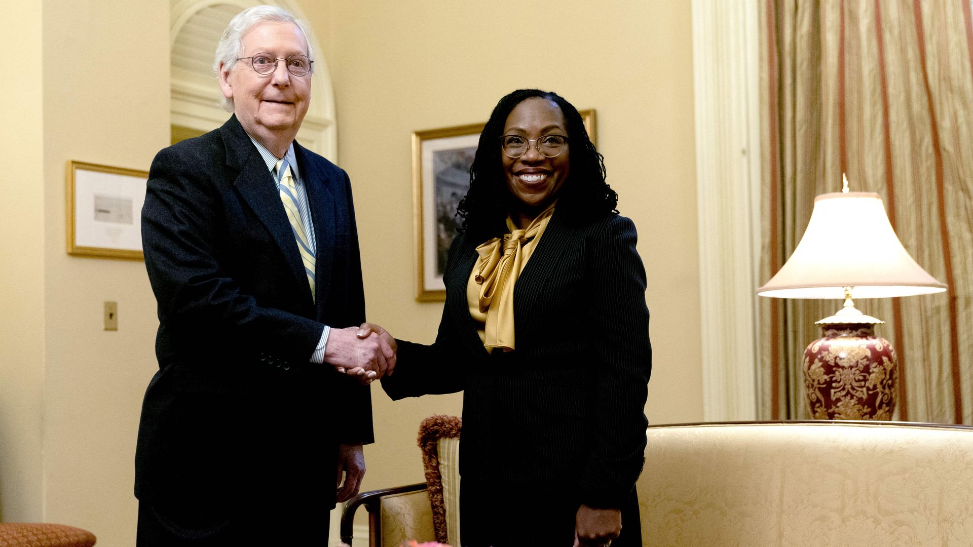 Senate Minority Leader Mitch McConnell is seen shaking hands with Judge Ketanji Brown Jackson during a visit to his office.